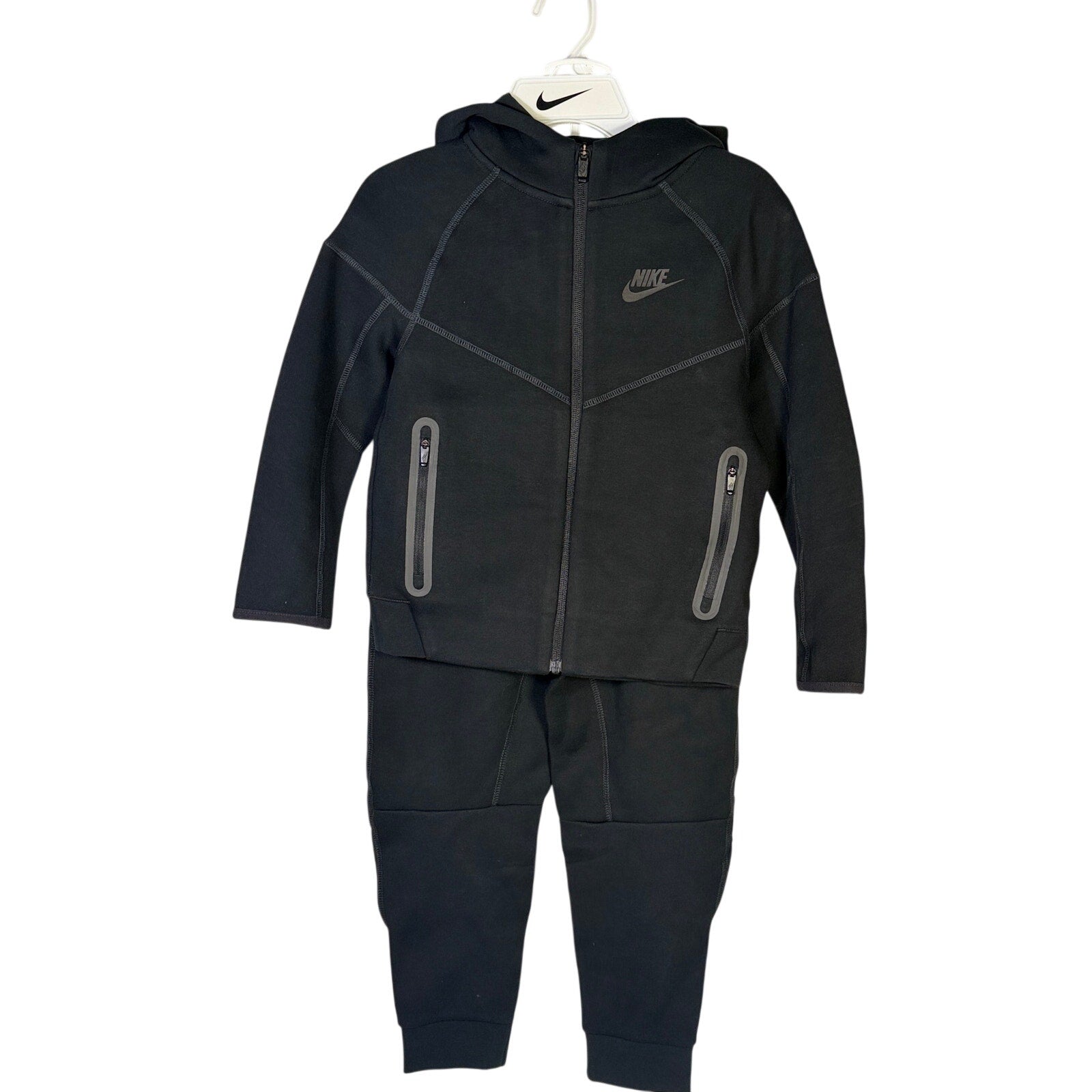 Nike Kids Tech Fleece full-zip hoodie and jogger set in black, size 7, featuring Nike branding and comfortable athletic design.