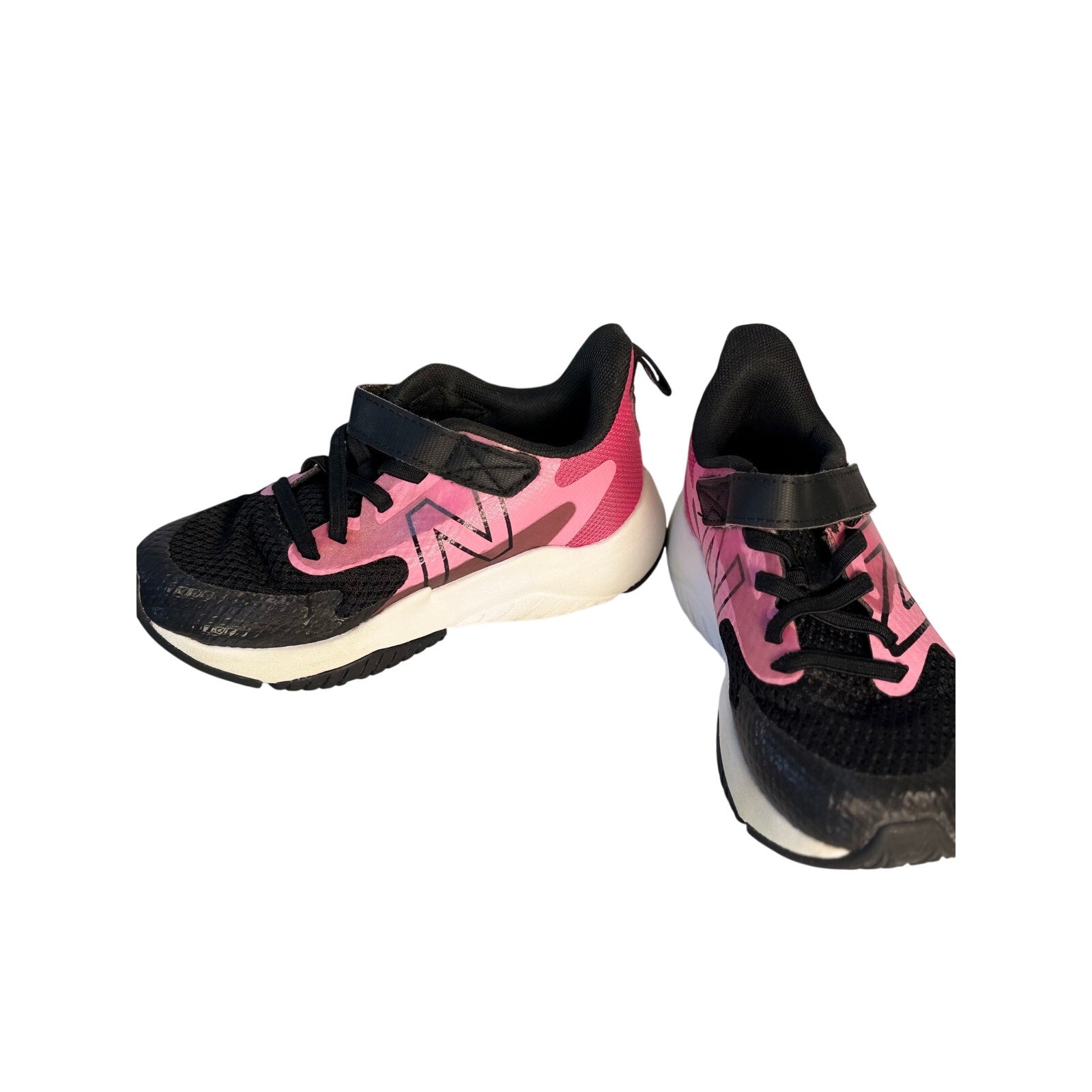 New Balance kids' black and pink athletic running shoes with hook and loop straps, size 11 US, designed for active children.
