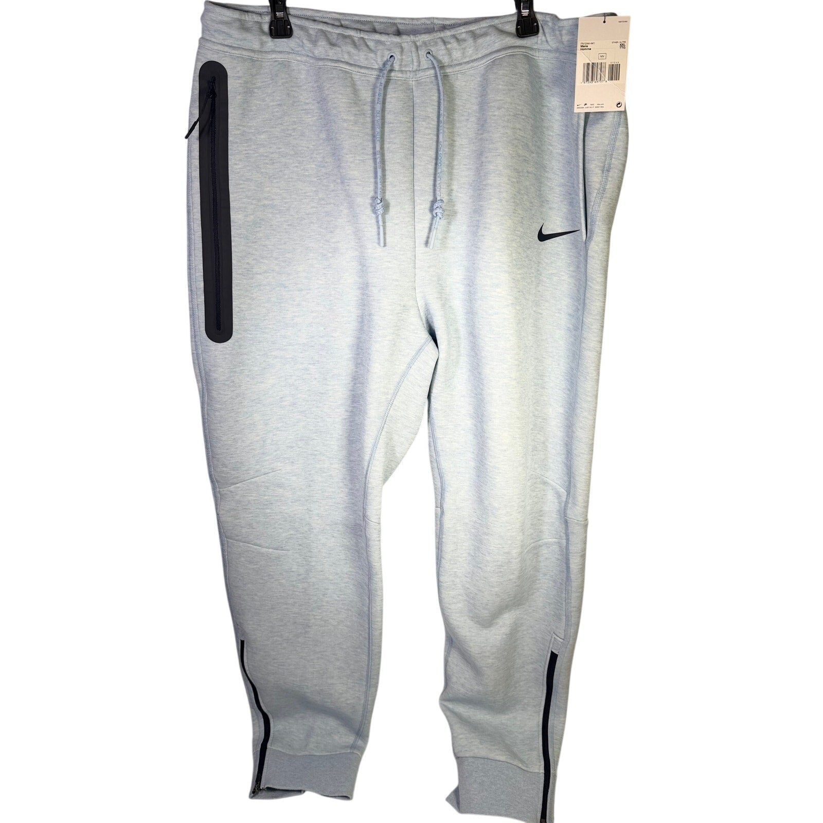 Nike Sportswear Tech Fleece jogger pants for men in light blue heather, shown in relaxed fit with elastic cuffs and waistband.