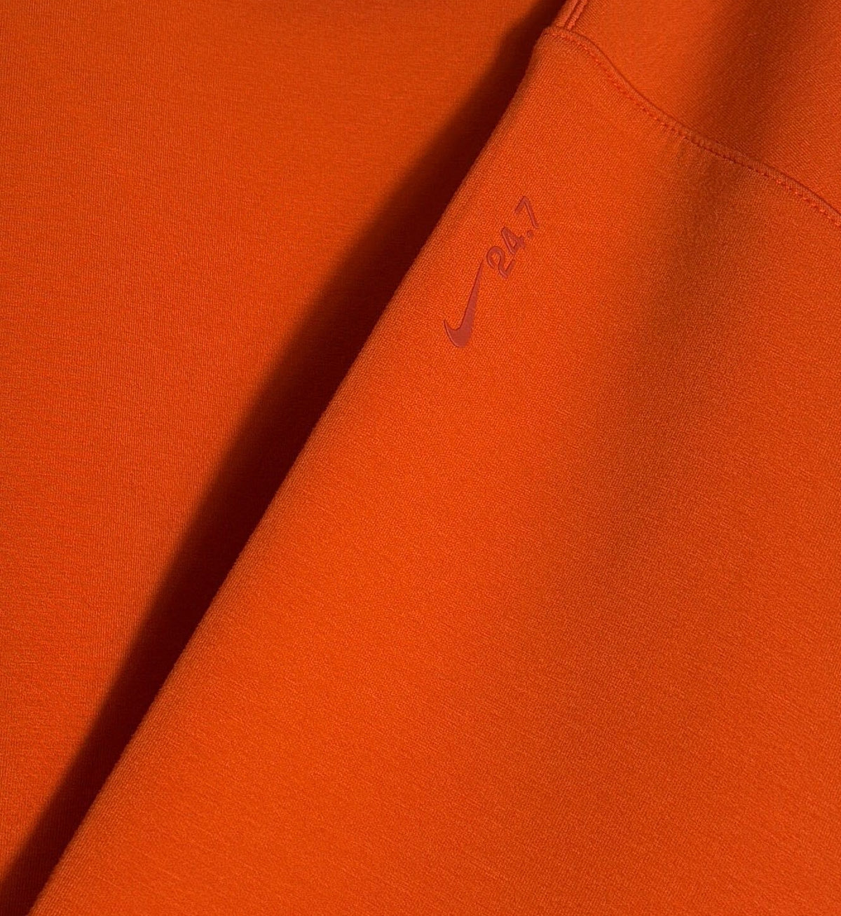 Nike 24.7 women's oversized cropped crew sweatshirt in bright orange, size small, with Nike logo on the front.