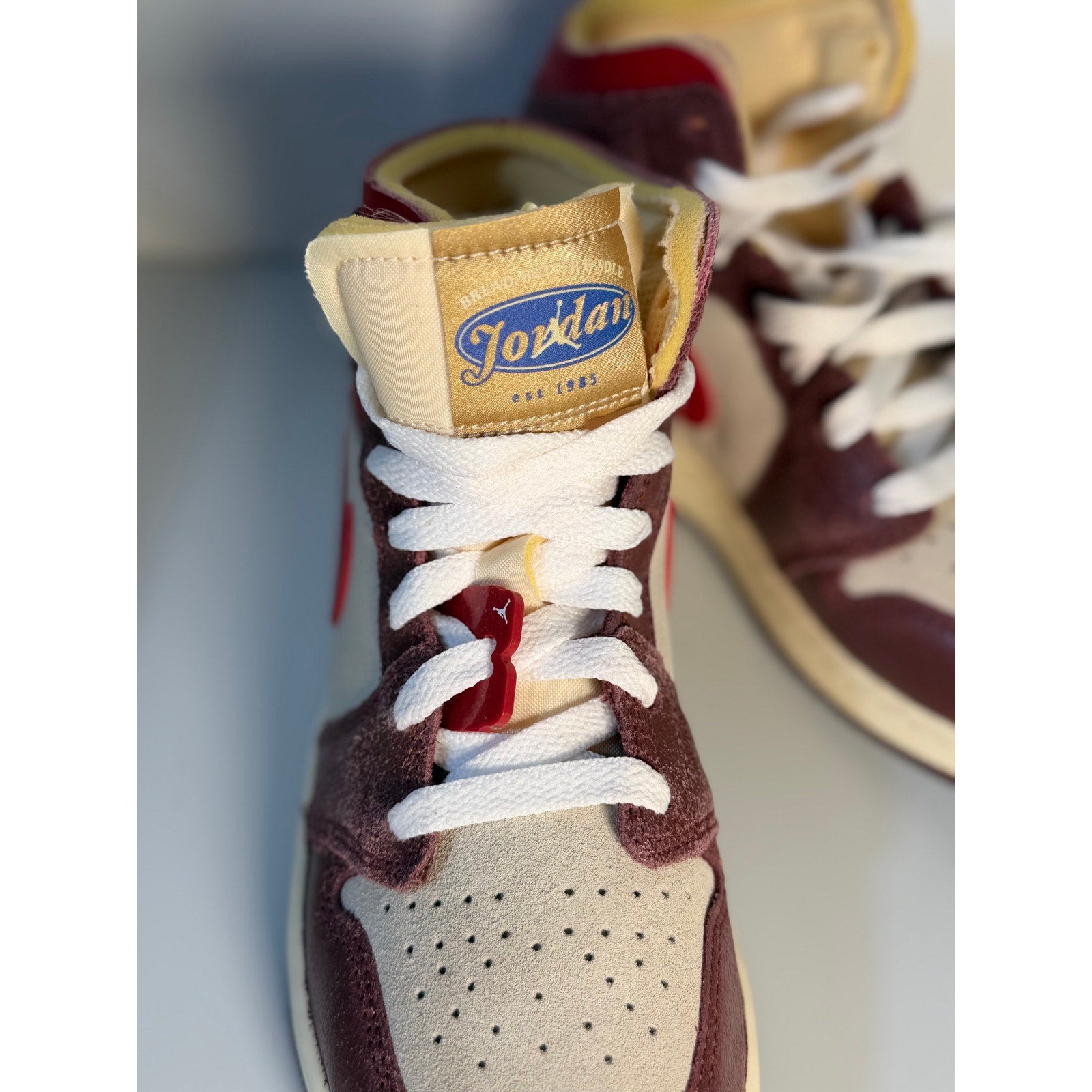 Nike Air Jordan 1 Mid SE Craft sneakers in sail, red, and brown colorway, men's size 4, showing the stylish design and materials.