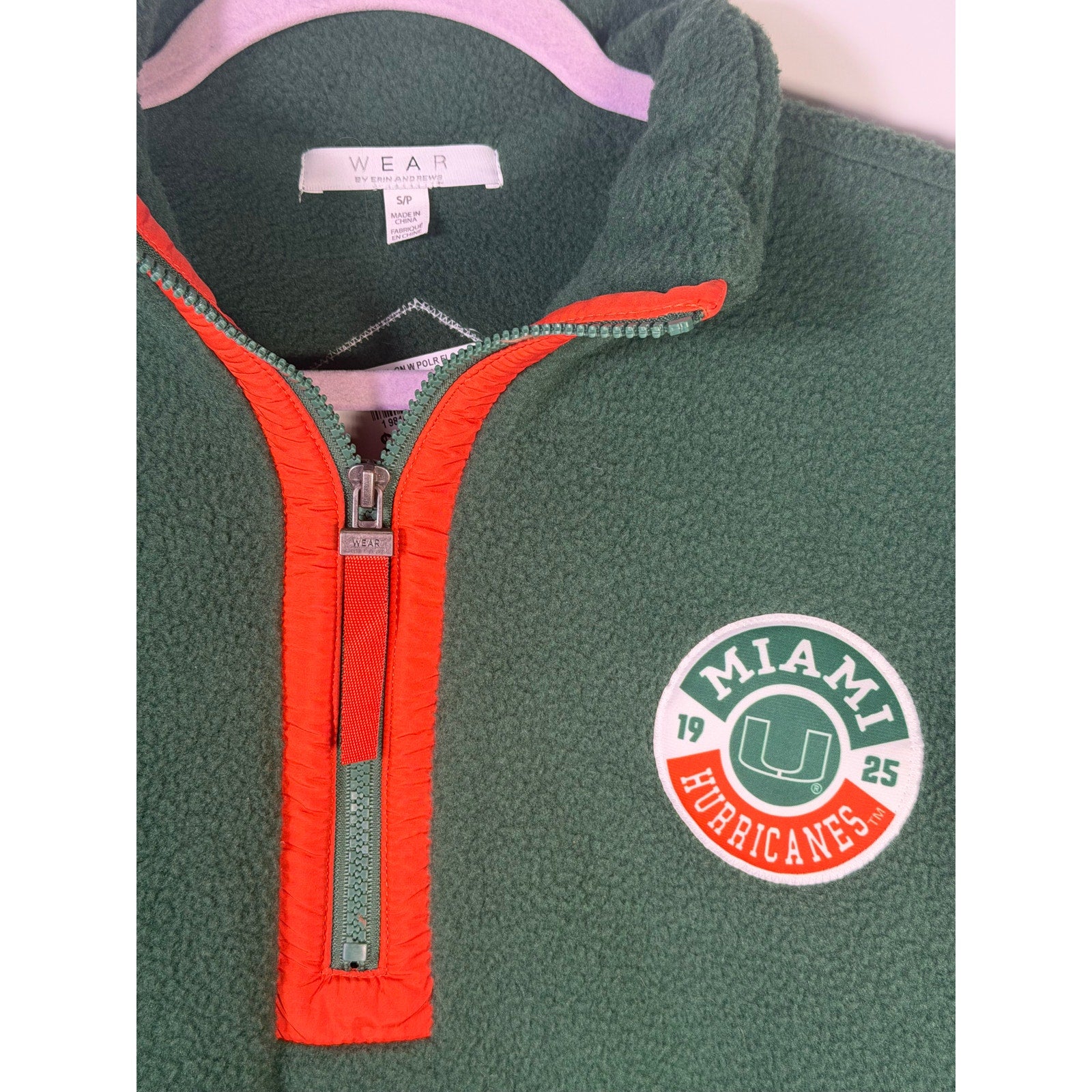 Wear by Erin Andrews women's Miami Hurricanes green quarter-zip fleece sweatshirt, size small, shown on a model.