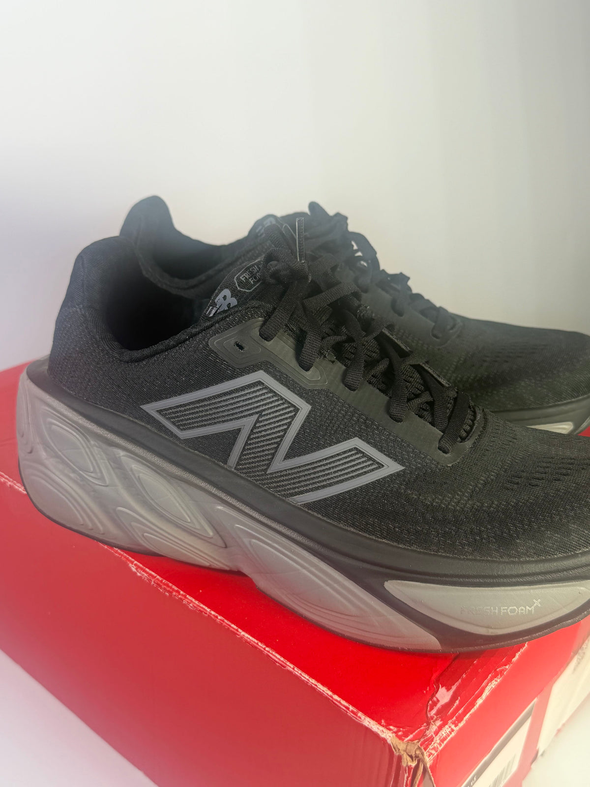 Men's black New Balance Fresh Foam X More v5 running shoes with breathable mesh and cushioned soles, size 11, D width.
