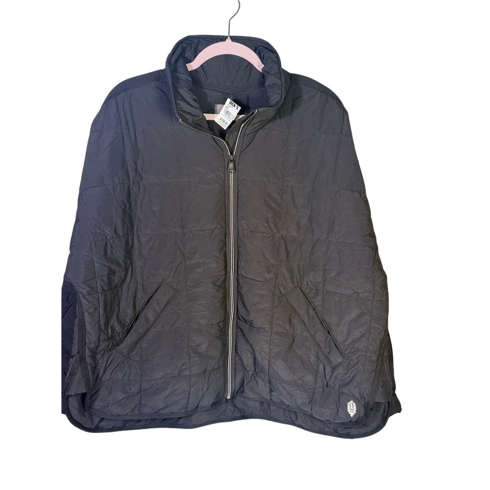 Black quilted full zip jacket for women by Free People Movement, size large, shown on a hanger.