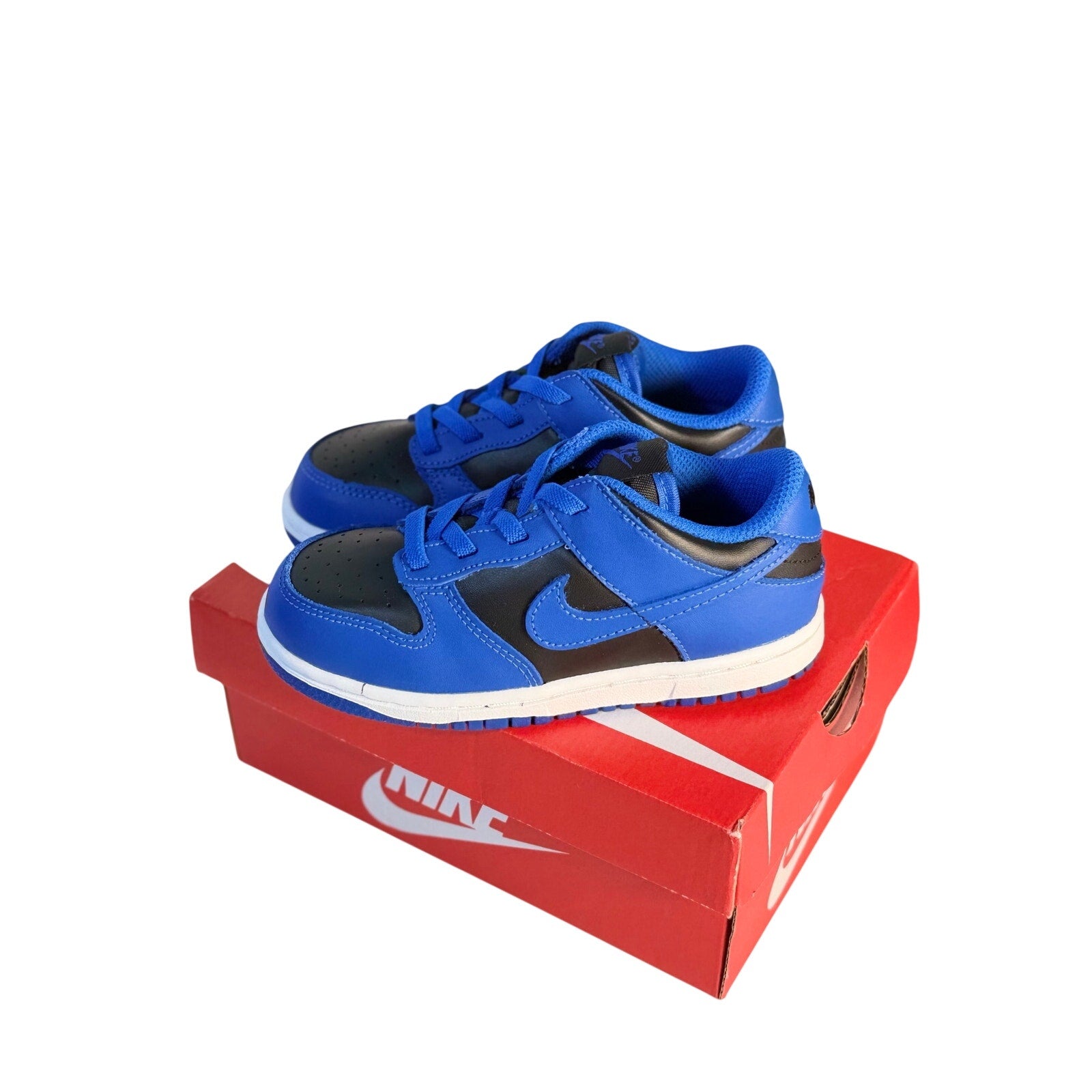 Nike Dunk Low GS sneakers for kids featuring royal blue and black athletic shoes with white accents and Nike branding.