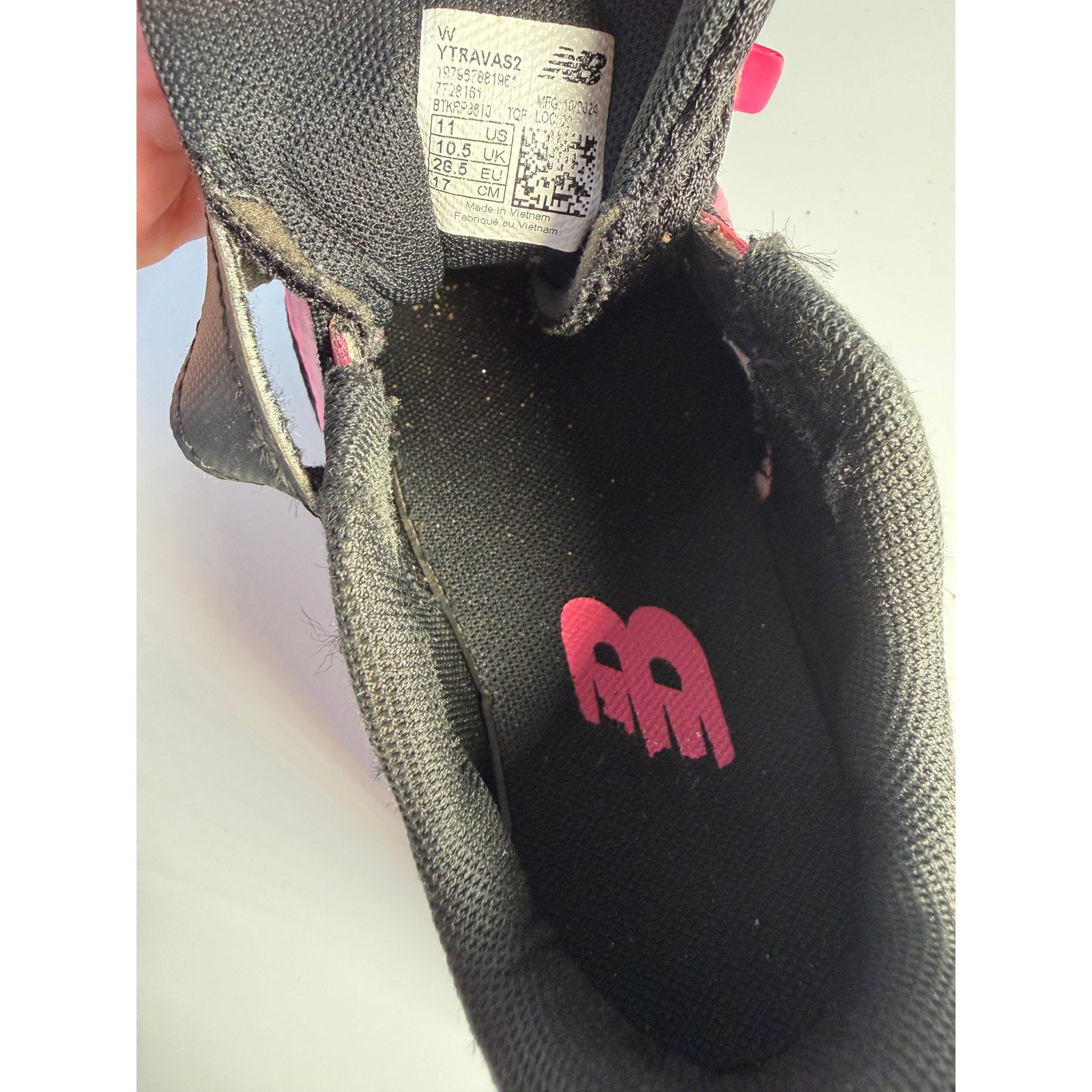 New Balance kids' black and pink athletic running shoes with hook and loop straps, size 11 US, for active youngsters.