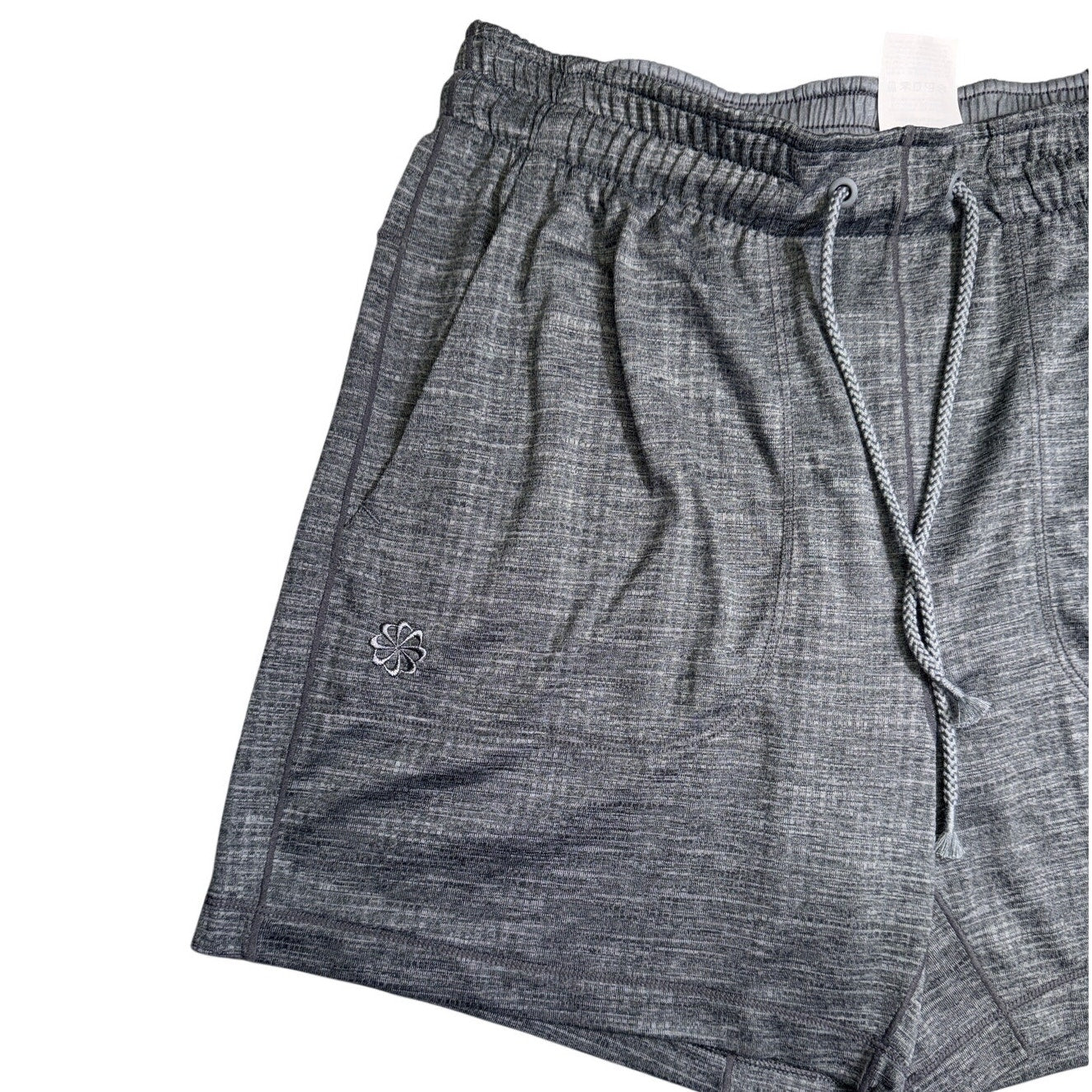 Gray Nike Yoga men's shorts with Dri-FIT fabric, drawstring waist, shown flat with elastic waistband and Nike logo.