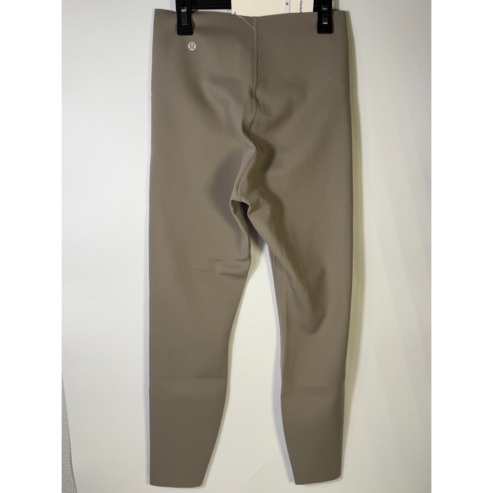 Lululemon Glow Up super-high-rise leggings in taupe gray, size 8, featuring a tight fit and 25-inch length.