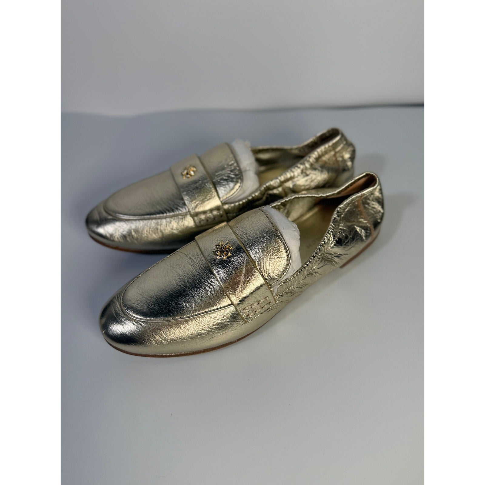 Tory Burch women's gold metallic leather slip-on loafers, size 5M, stylish flats with sleek design and comfortable fit