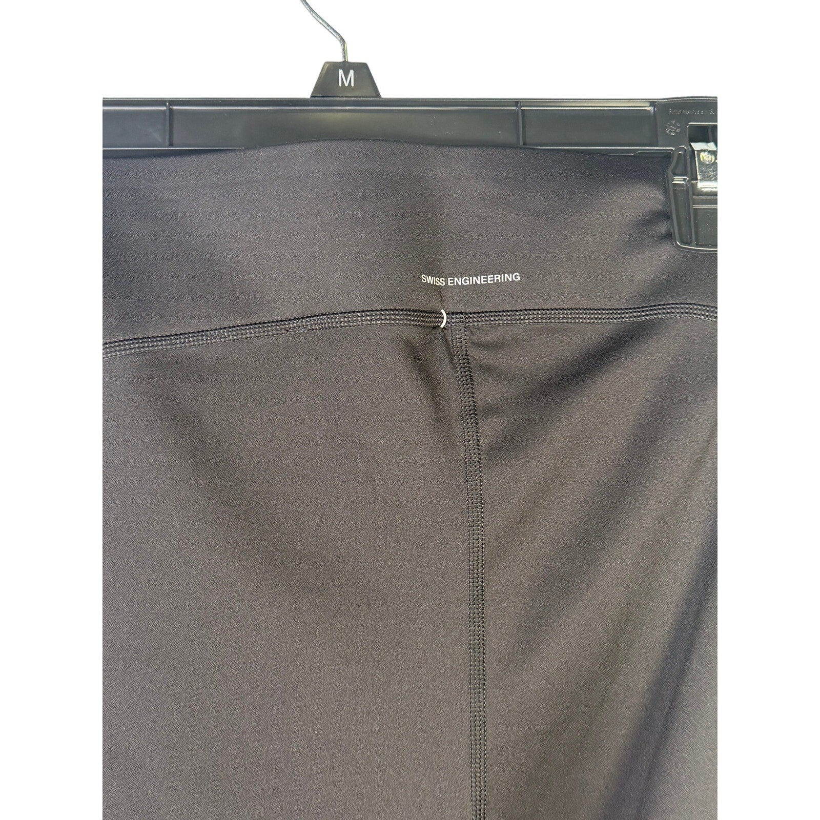 Black On Women’s Train Tights 7/8 leggings in size M, shown laid flat with a smooth, fitted design and elastic waistband.