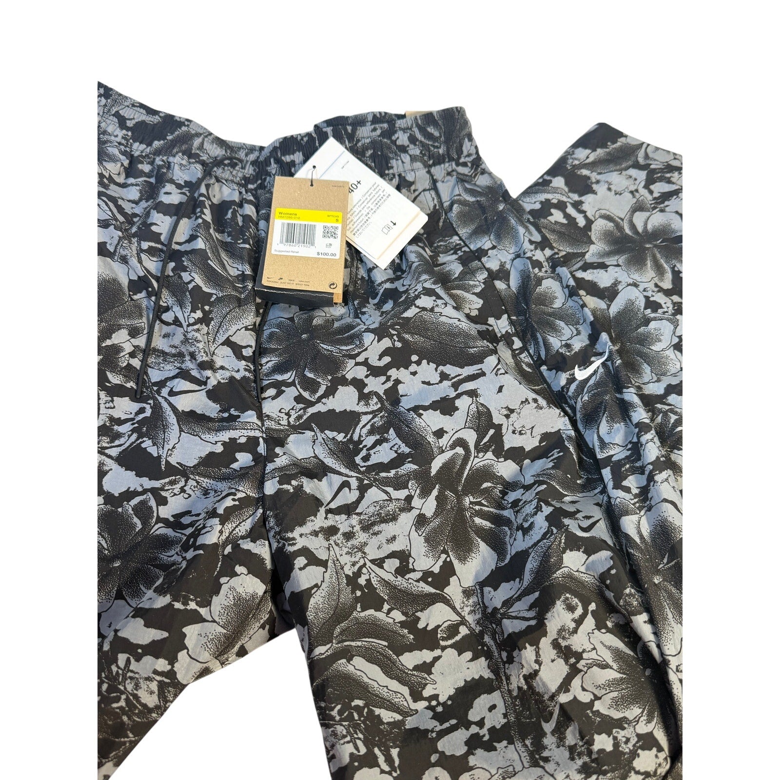 Nike Dri-FIT ADV women's running shorts in black and gray floral print, size small, with lightweight, breathable fabric.