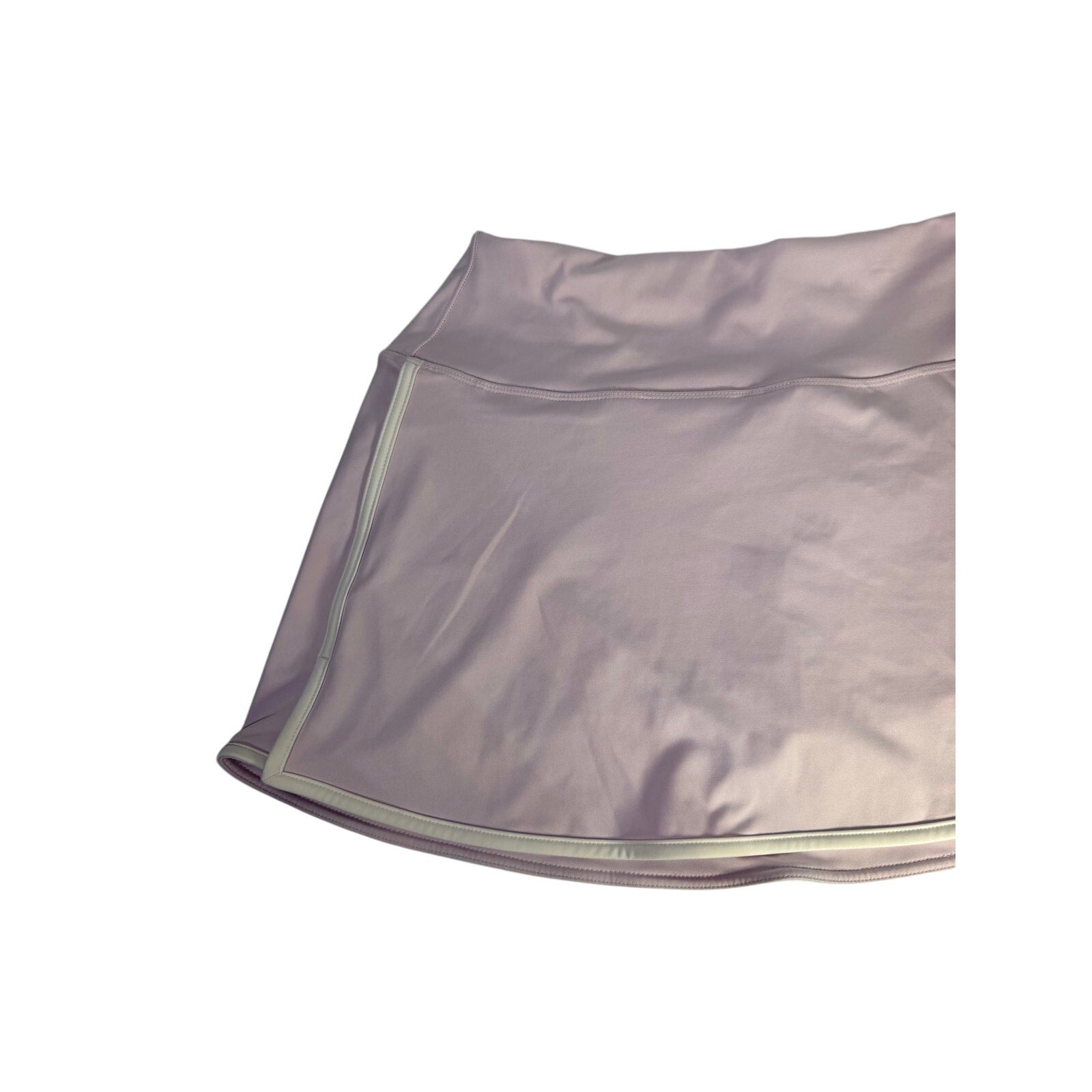 DSG Women’s Activate high-rise lavender skort with built-in shorts, size L, shown on a model in a sporty outdoor setting.