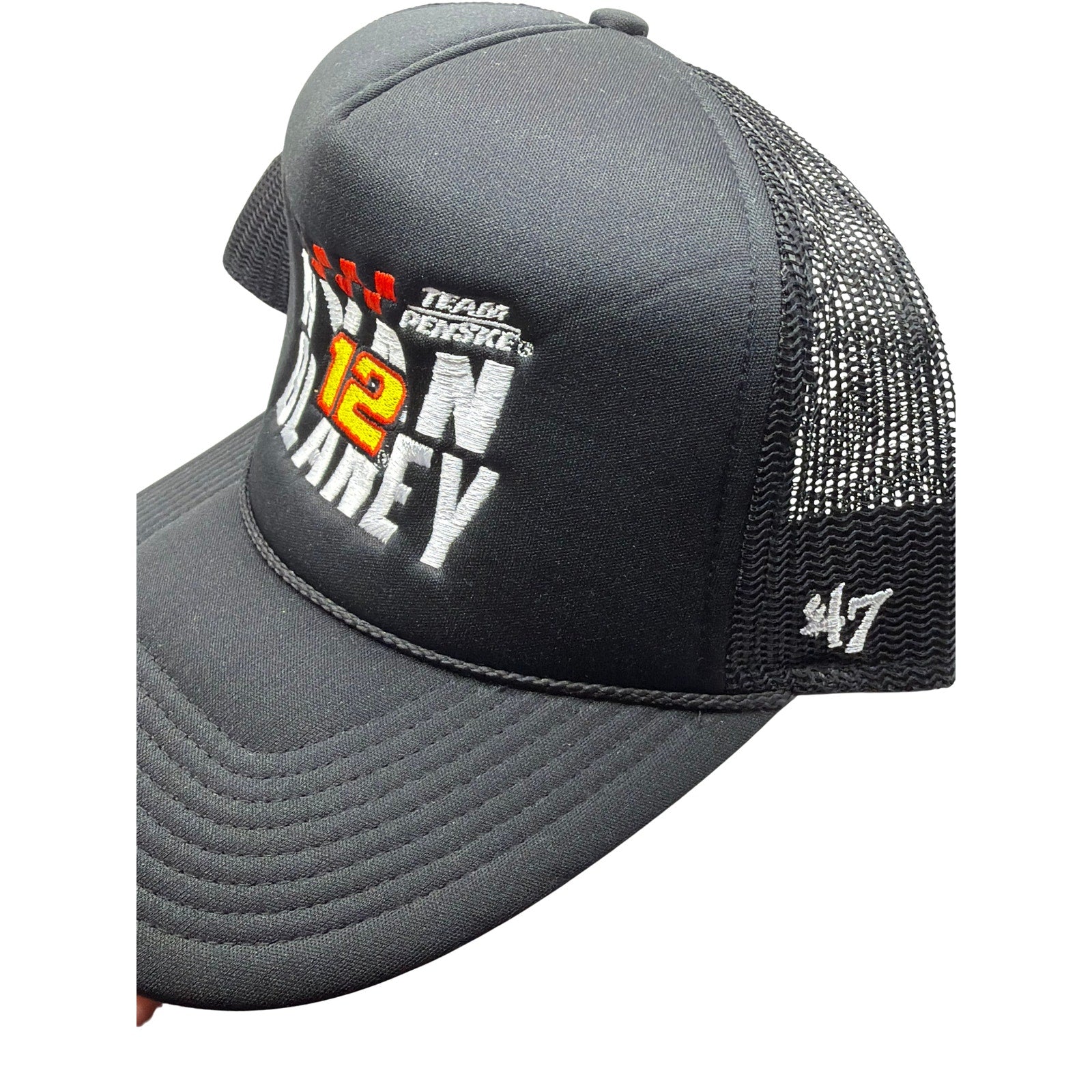 Black NASCAR Ryan Blaney #12 Team Penske ’47 Trucker Snapback Hat with embroidered logo and mesh back for a casual sporty look.