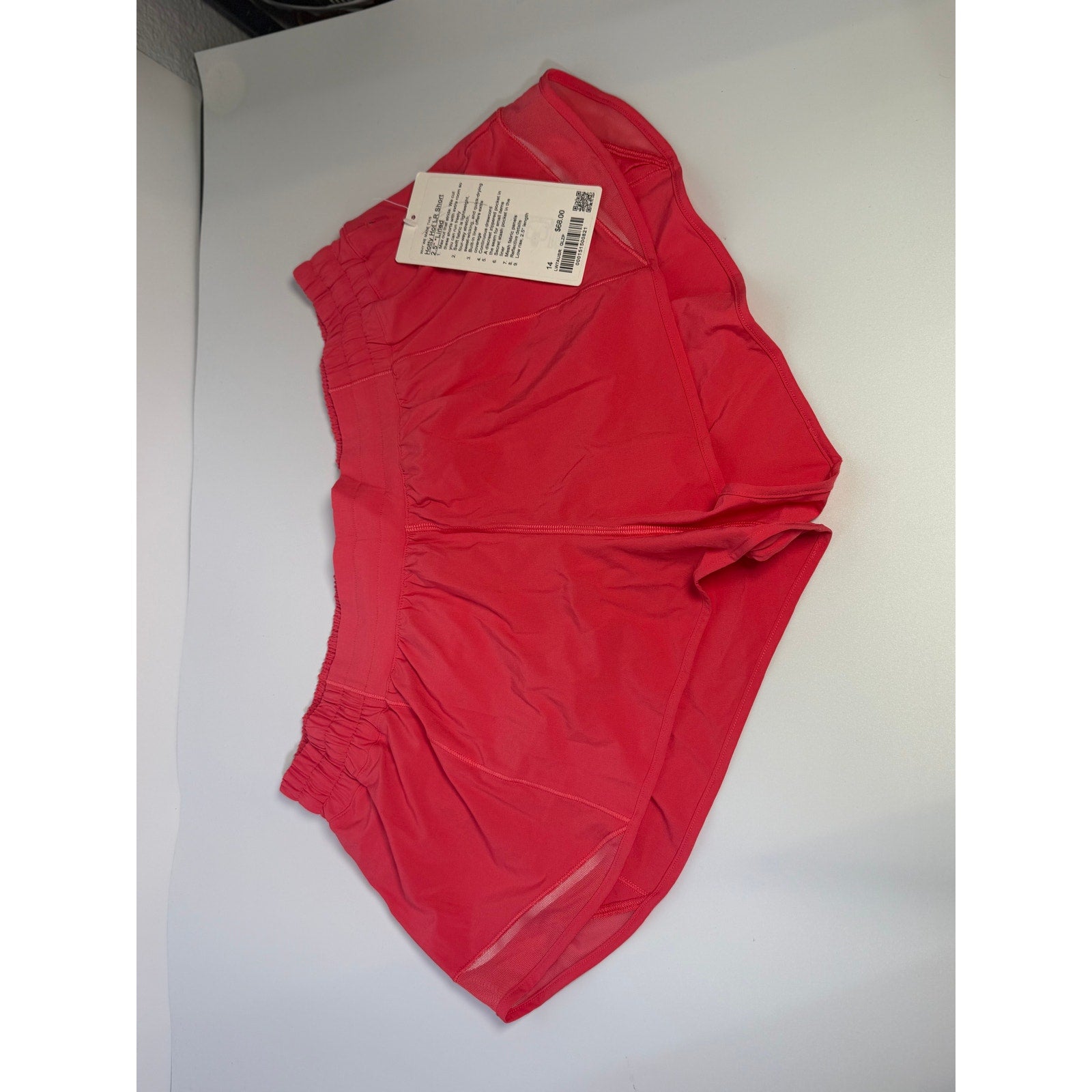 Lululemon Hotty Hot low-rise lined shorts in Glaze Pink, women's size 14, with 2.5-inch inseam, lightweight and comfortable.