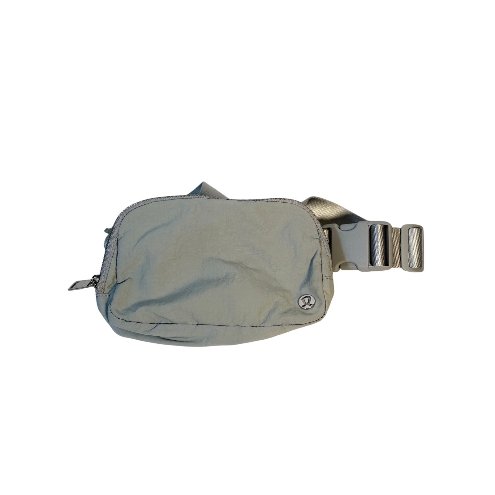 Lululemon Everywhere Belt Bag in light gray, crossbody waist pack with adjustable strap and compact handbag design.