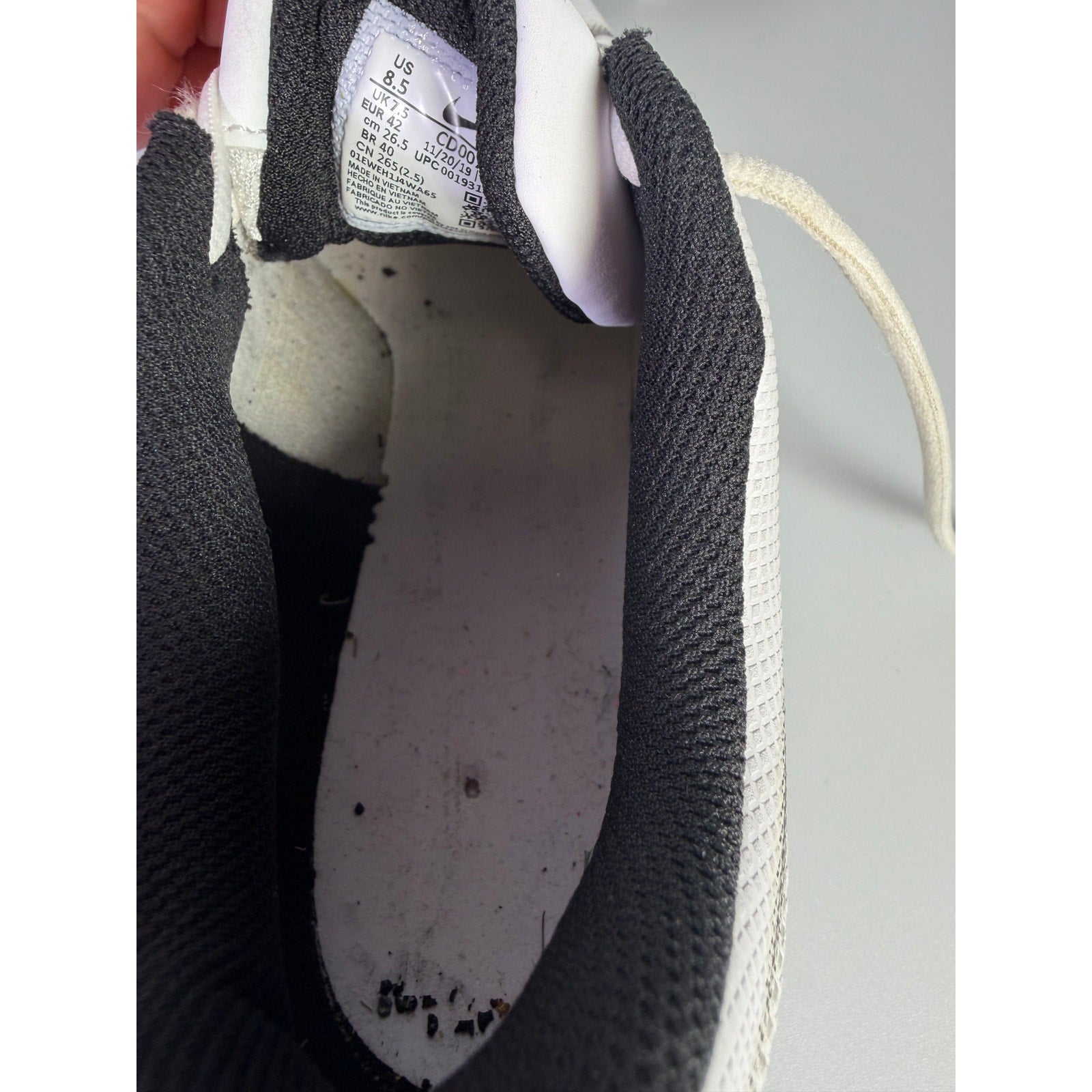 Nike Vapor football cleats in white and black, men's size 8.5 US, with cleated outsole and Nike branding on the shoes.