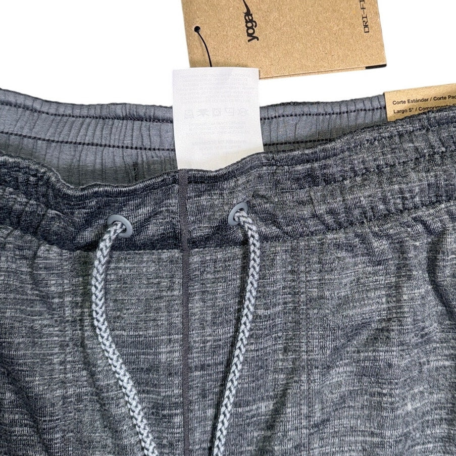 Gray Nike men's yoga shorts with Dri-FIT fabric and drawstring waist, offering comfort and performance for active wear.