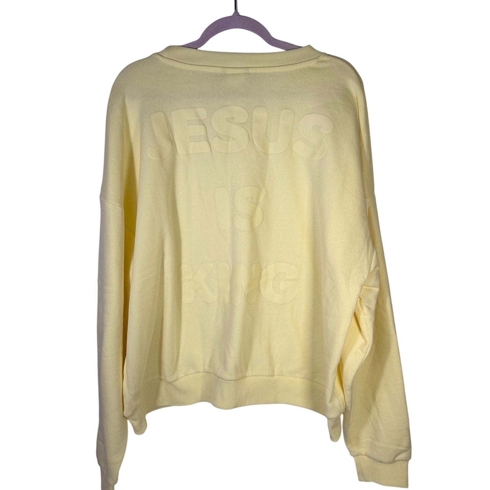 Yellow crewneck sweatshirt by Kind Regards featuring Revelation 19:16 Jesus Is King quote, size XL, casual fit.