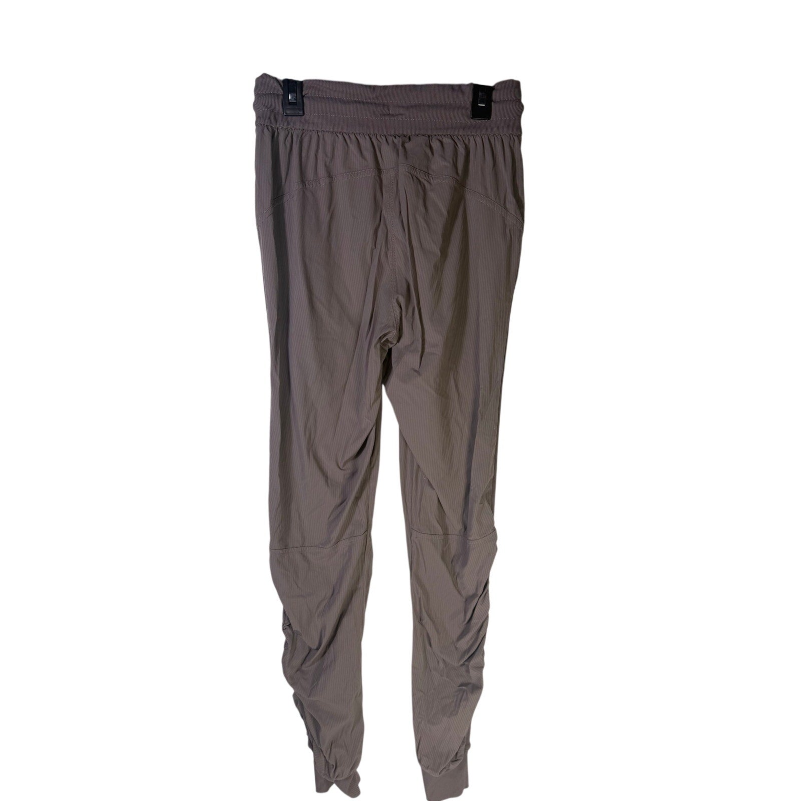 Lululemon women's taupe gray high-rise ruched tapered pants size 4, showing the fitted waist and tapered leg design.