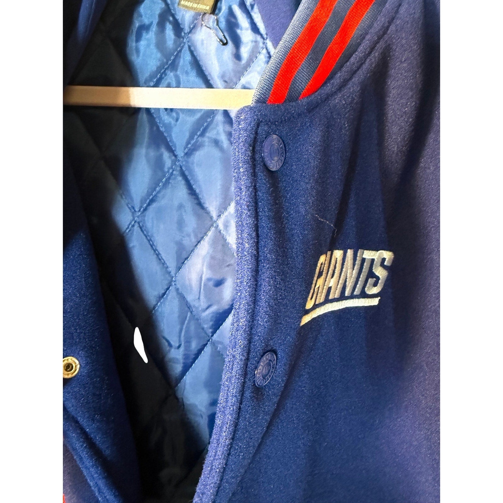 Men's New York Giants NFL varsity jacket in medium size, featuring team logo and classic varsity style with wool and leather details.