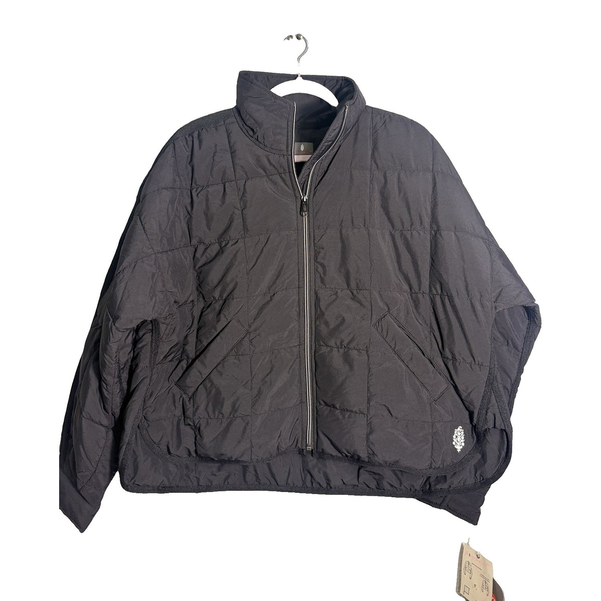 Black Free People Movement Pippa packable puffer jacket with PrimaLoft insulation, women's XS, shown folded and partially unfolded.