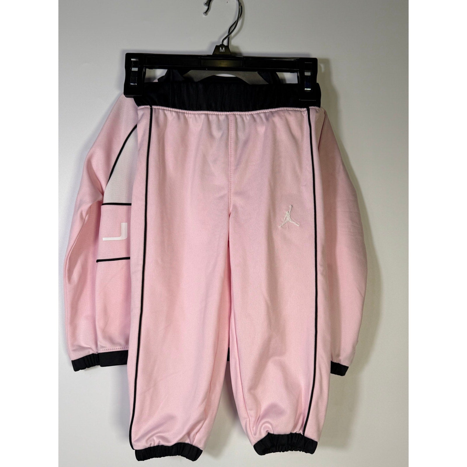 Pink and black Jordan toddler girls 2-piece track jacket and pants set, size 2T, with sporty design and brand logo details.