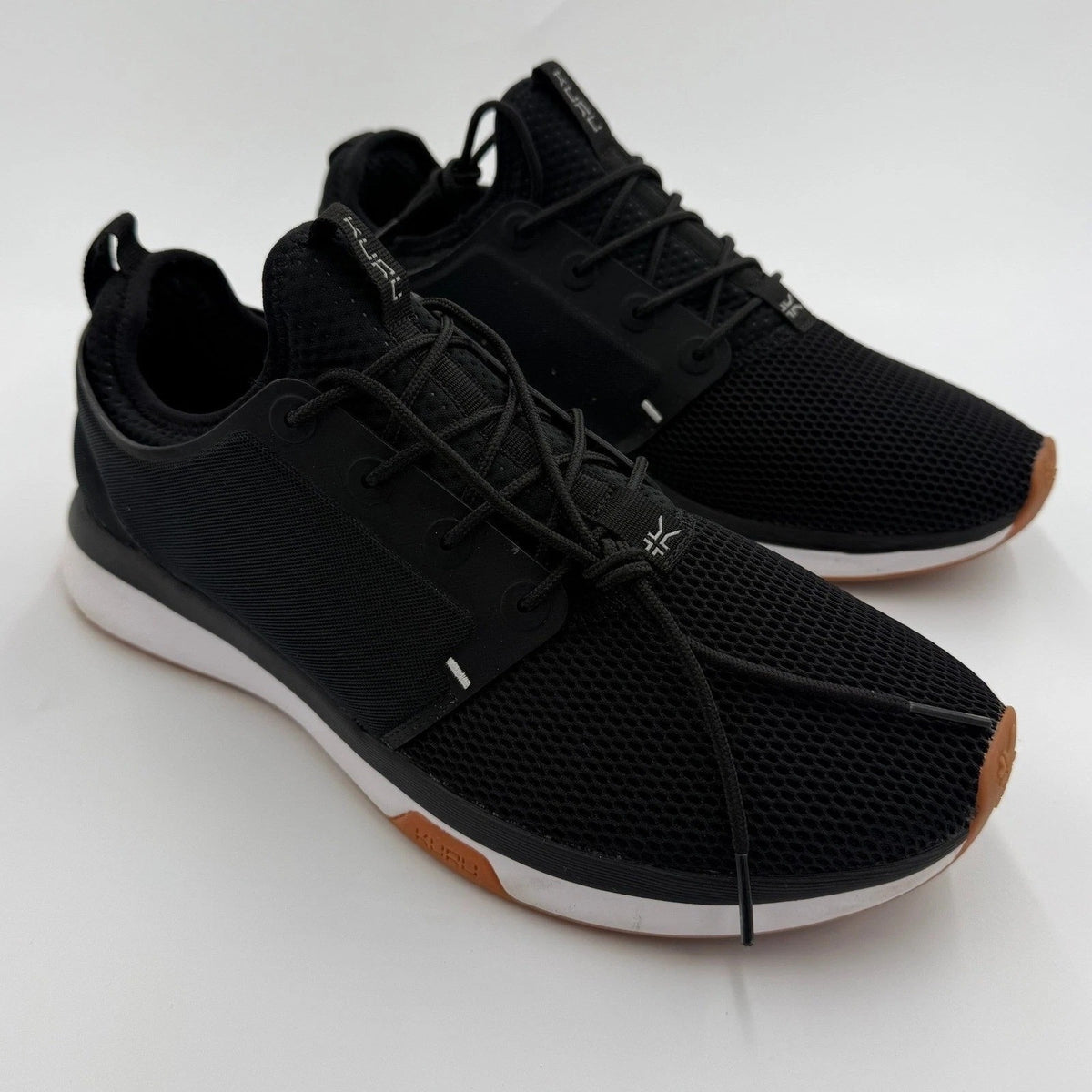 KURU ATOM Women's 12 Medium Jet Black and White Gum supportive walking sneakers with cushioned soles and sporty design.