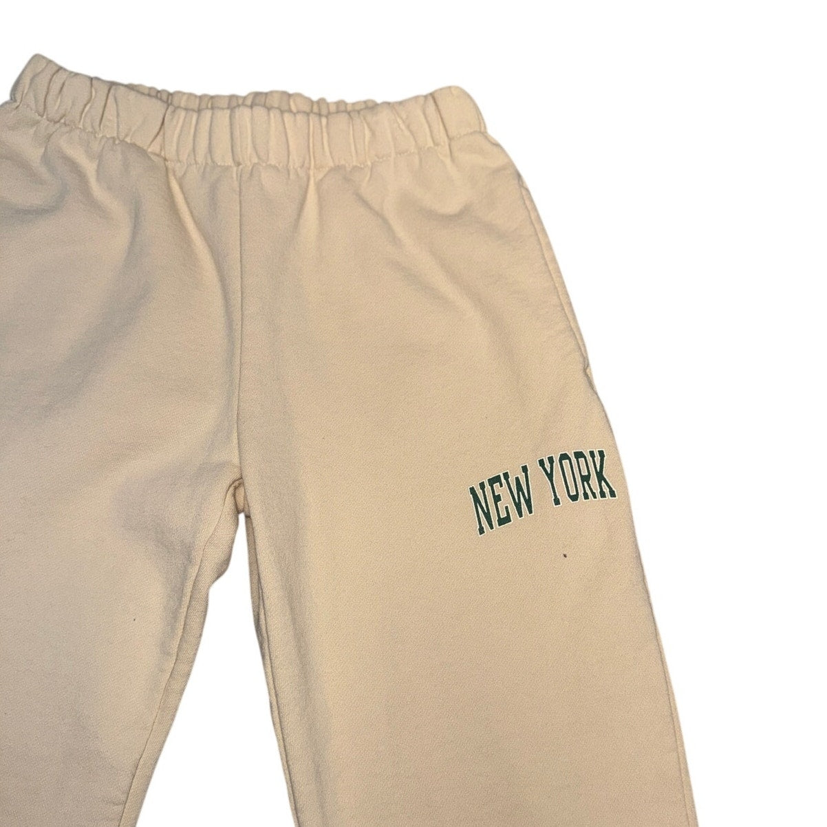 Cream beige New York graphic jogger sweatpants by Brandy Melville with elastic waist and relaxed fit in size large.