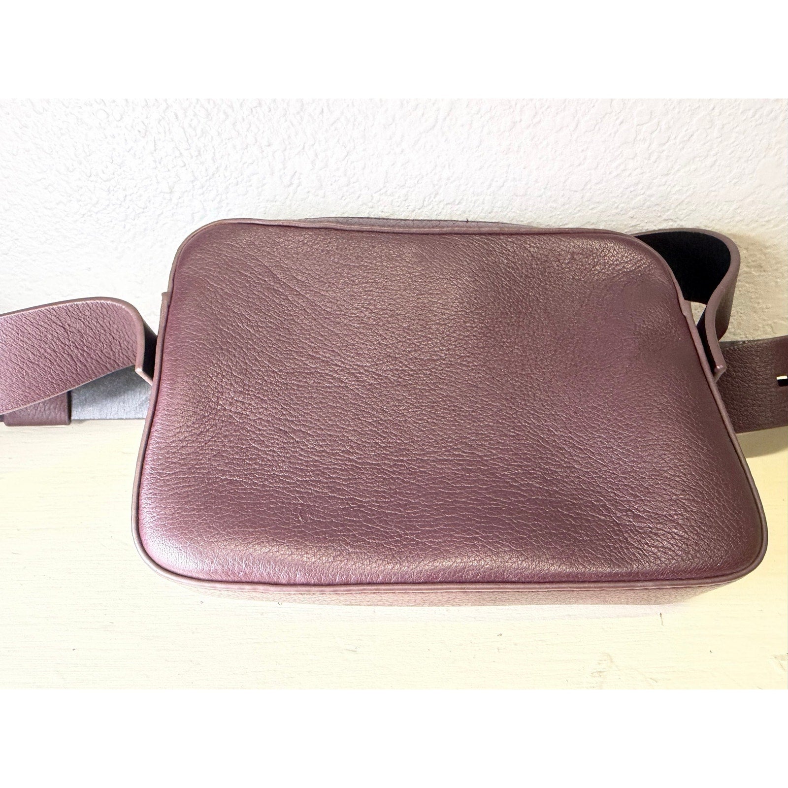 AllSaints burgundy pebbled leather women's crossbody handbag with adjustable strap and camera bag style.