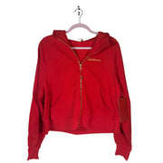 Lululemon women's red scuba oversized full zip hoodie, size M/L, with gold accents, displayed on a hanger.