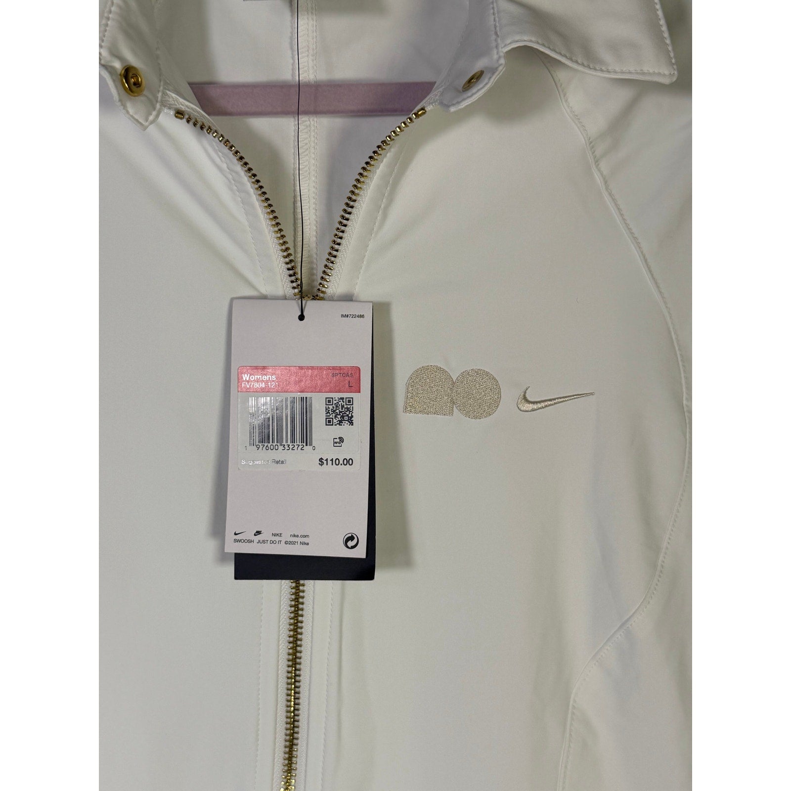 Nike women's long full zip jacket in cream with logo, size XL, displayed on a hanger.