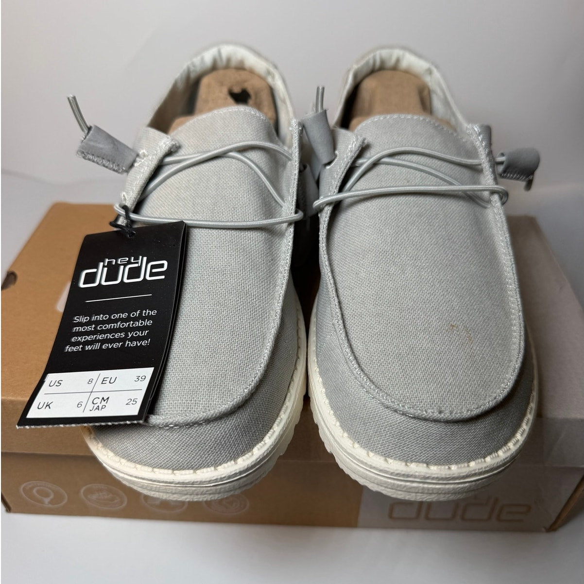 Light grey Hey Dude Wendy Chambray sneakers for women, size 8, featuring a casual slip-on style and comfortable fabric upper.
