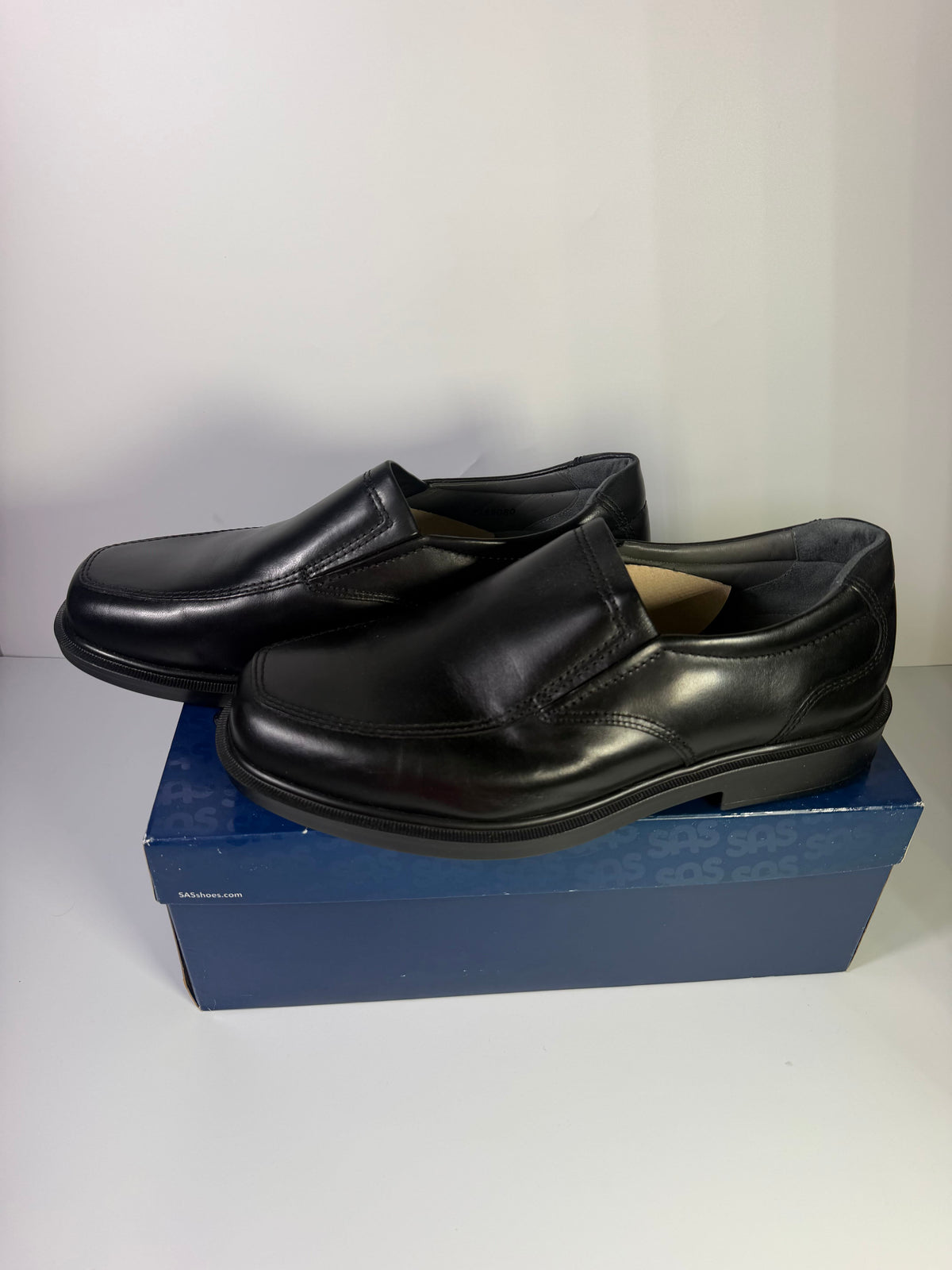 Black leather SAS men's slip-on loafers in size 11.5 wide, featuring a sleek flat design and cushioned insoles.
