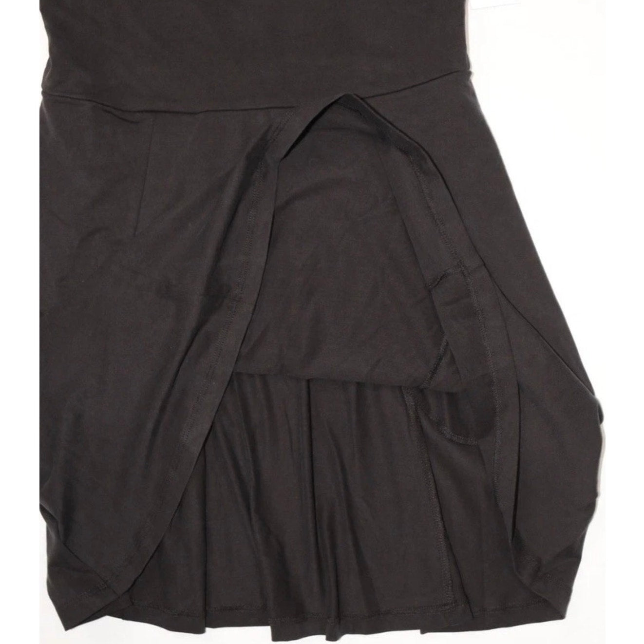 Beyond Yoga black Charmed Fit & Flare Mini Dress for women, size medium, shown hanging with a fitted waist and flared skirt.