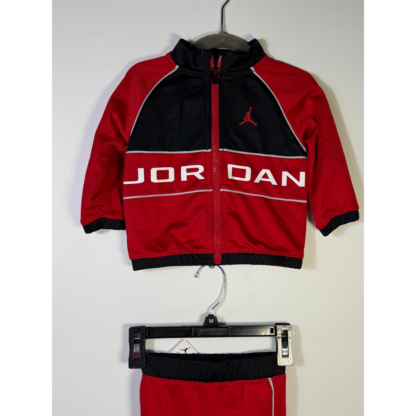 Jordan baby boys 2-piece tracksuit jacket and pants set in red and black for 12 months, new with tags.