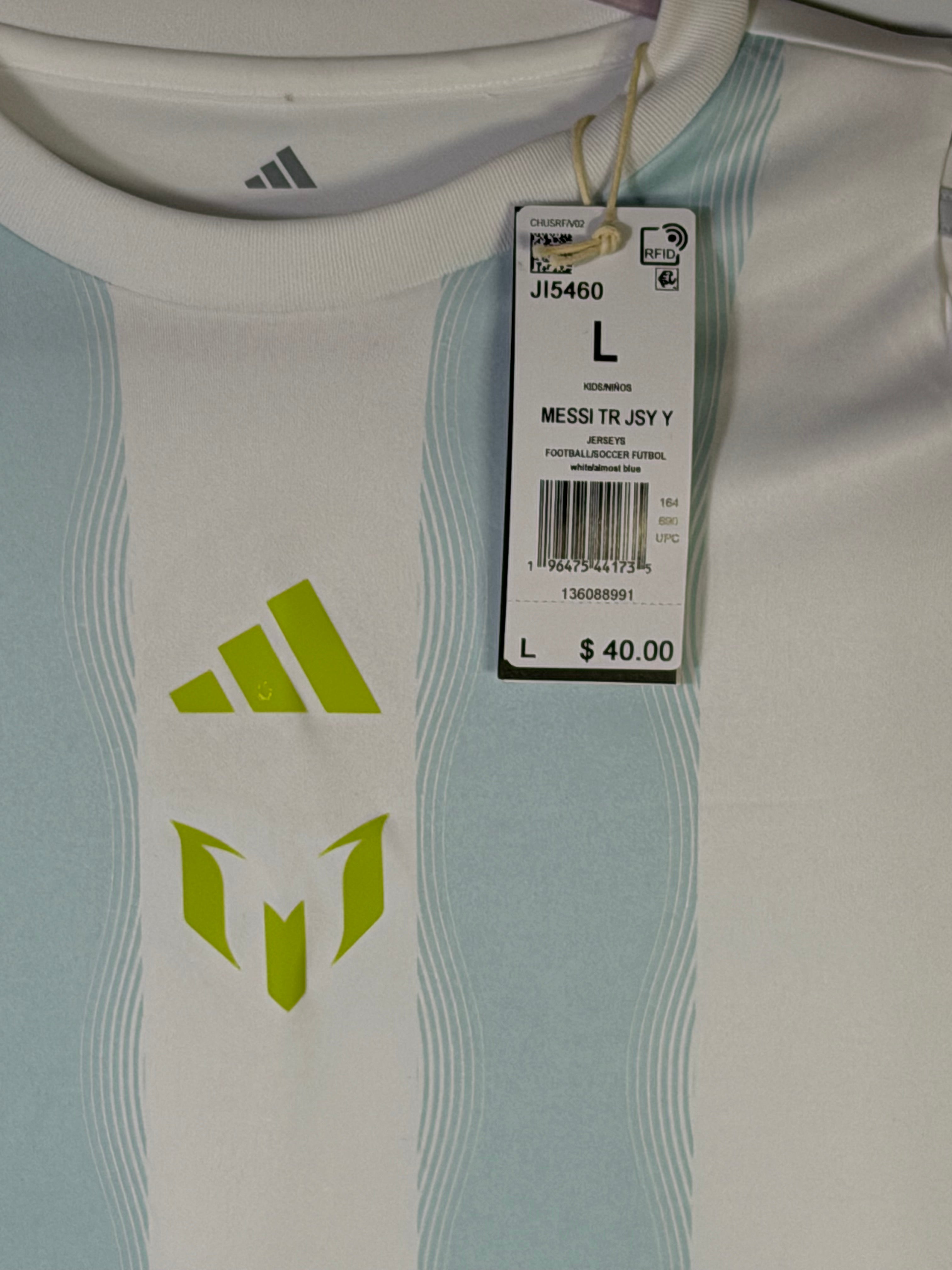 White Adidas Messi training jersey in size L, lightweight sports shirt with team logo and breathable fabric for athletic wear.
