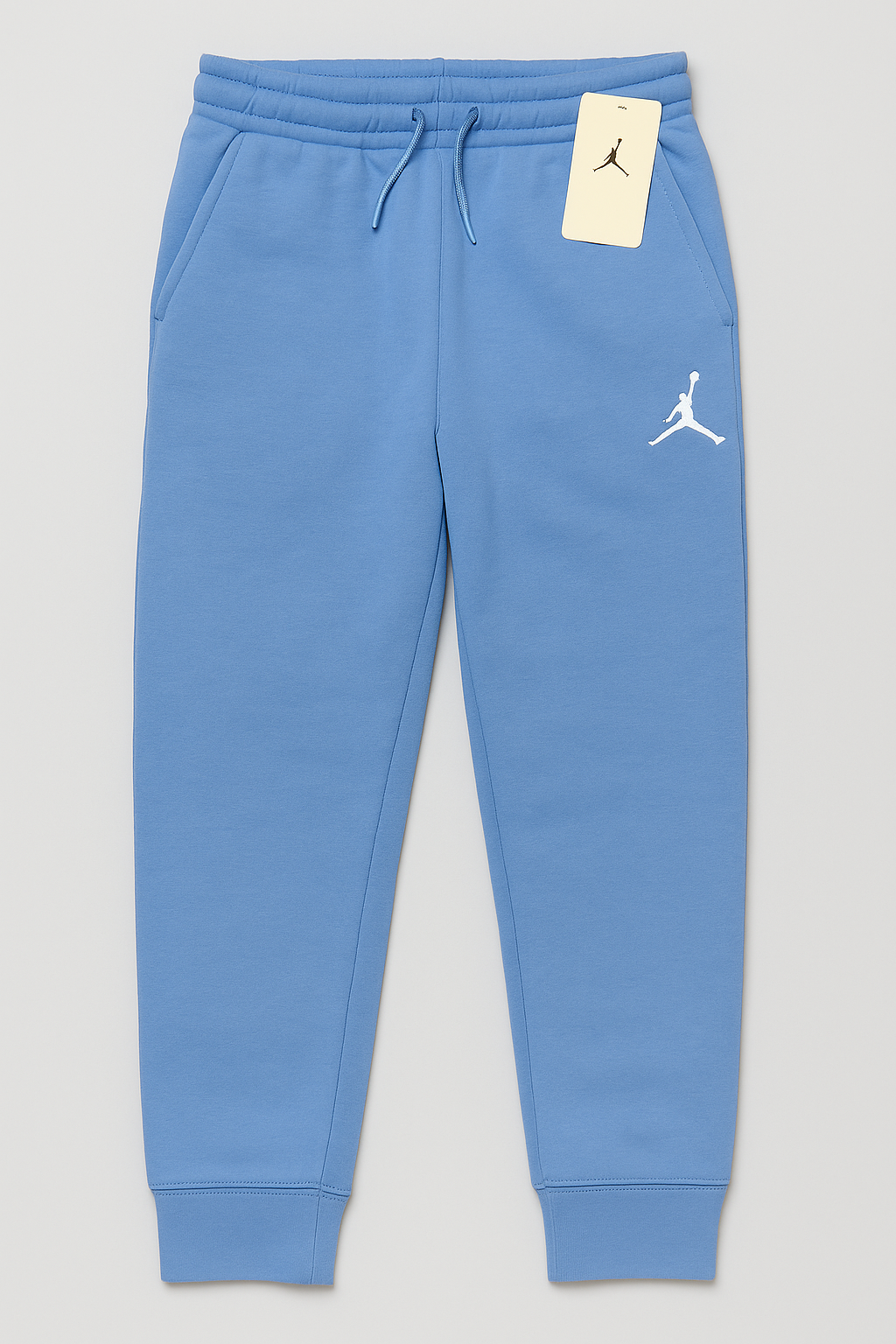 Jordan Essentials fleece pants in university blue, size 12–13, shown with relaxed fit and elastic waistband.