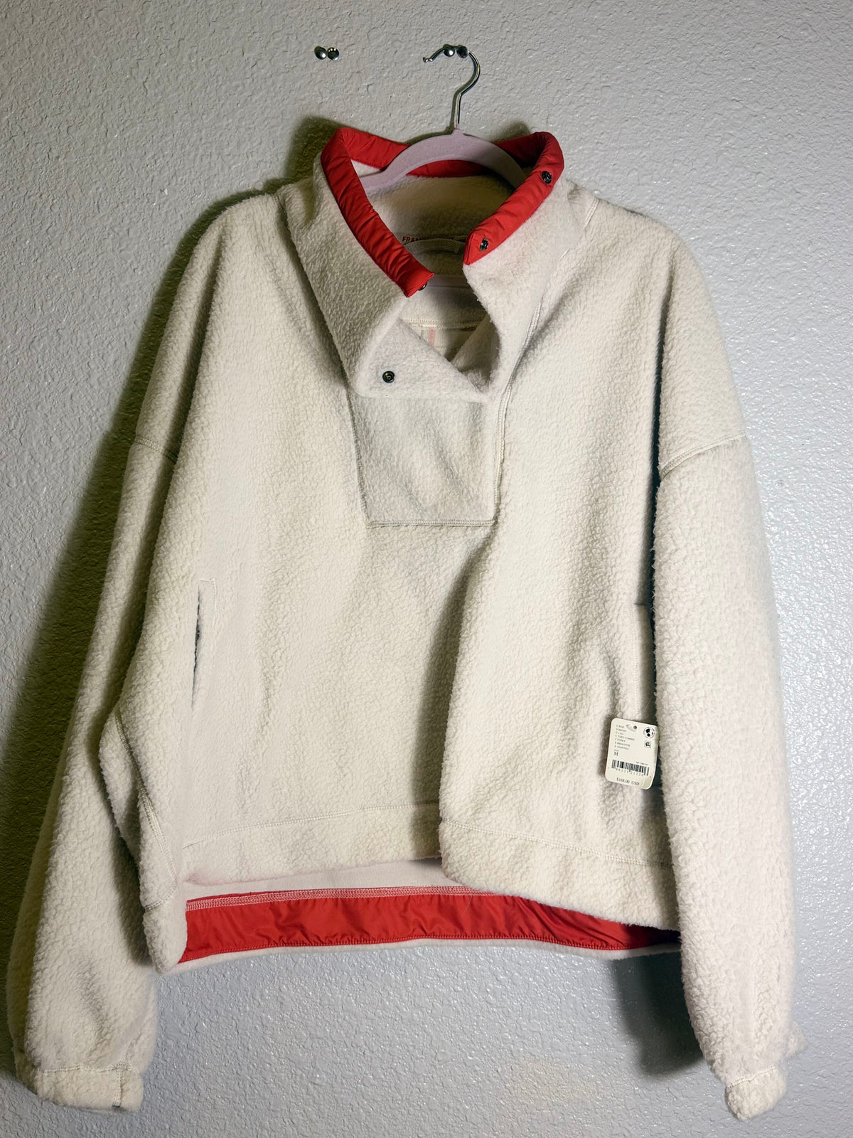 Free People FP Movement ivory fleece pullover for women, cozy fleece fabric, casual style, worn by a model.