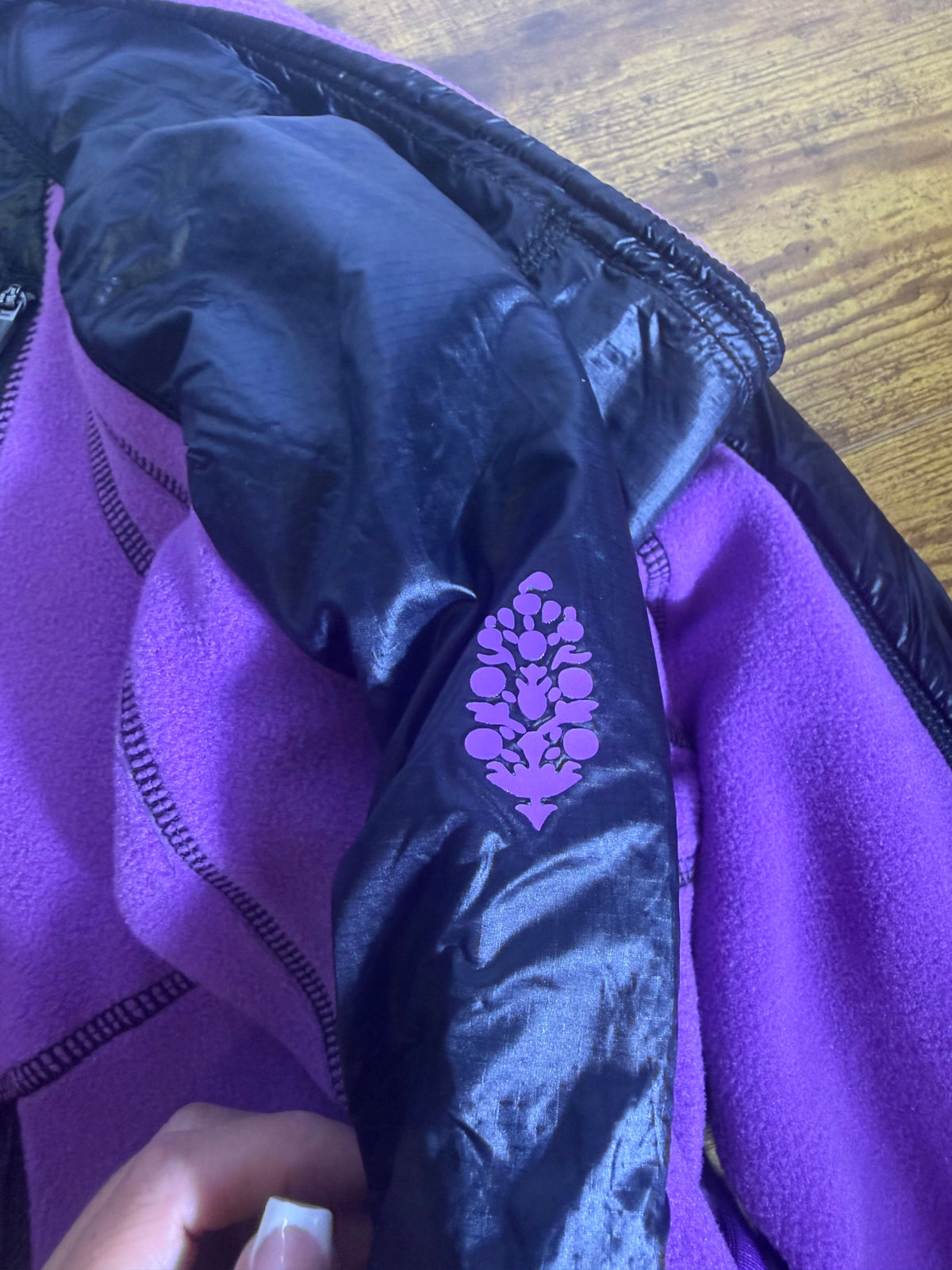Free People Movement cropped hooded fleece jacket in violet and black, size XS, featuring a cozy hood and soft fleece fabric.
