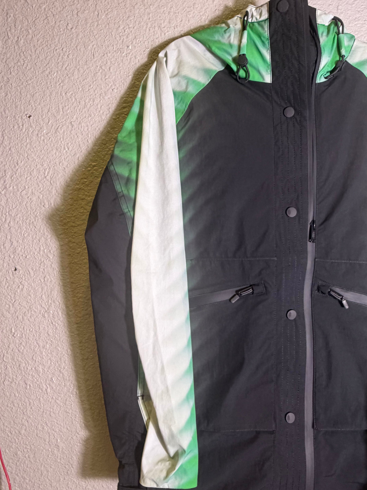Green and black FP Movement Alien Combo Hooded Anorak Jacket for women, XS, featuring a stylish hooded design and lightweight fabric.