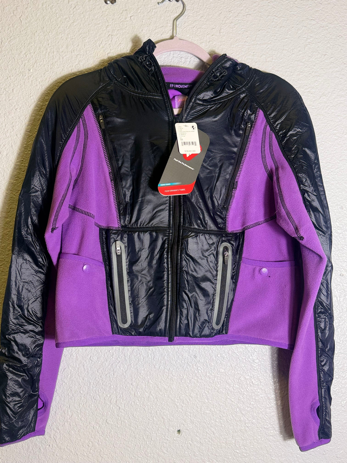 Free People Movement cropped hooded fleece jacket in violet and black, showing the cozy front view with drawstring hood.