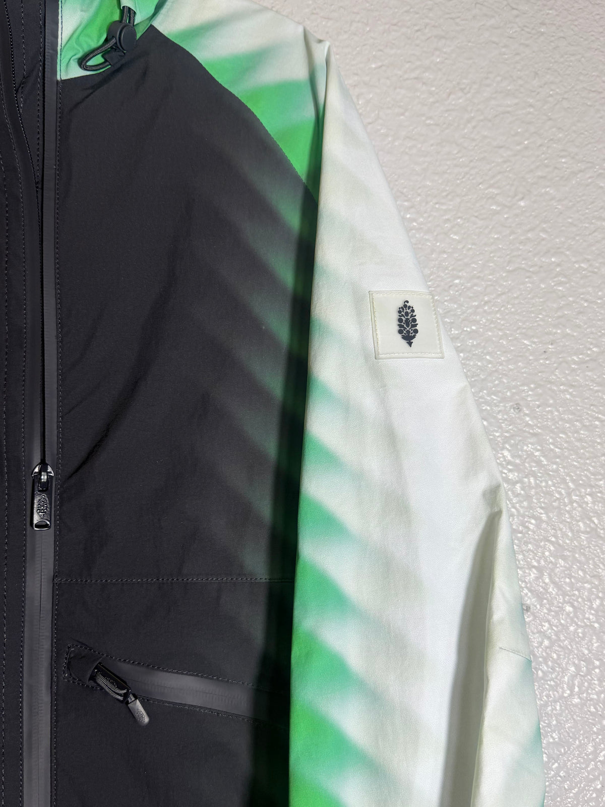 Green and black Free People FP Movement Alien Combo hooded anorak jacket for women, XS size, shown on a hanger.
