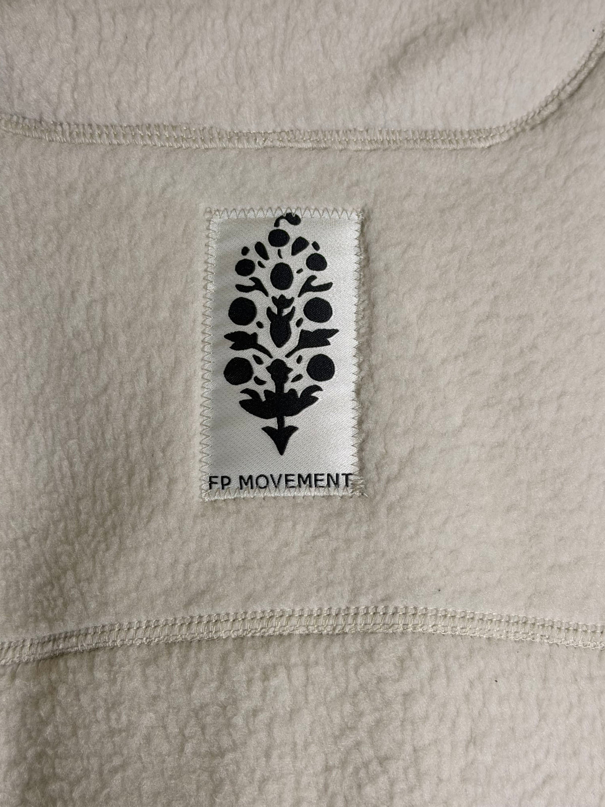 Free People FP Movement ivory fleece pullover for women, showing the cozy, textured fabric and relaxed fit.
