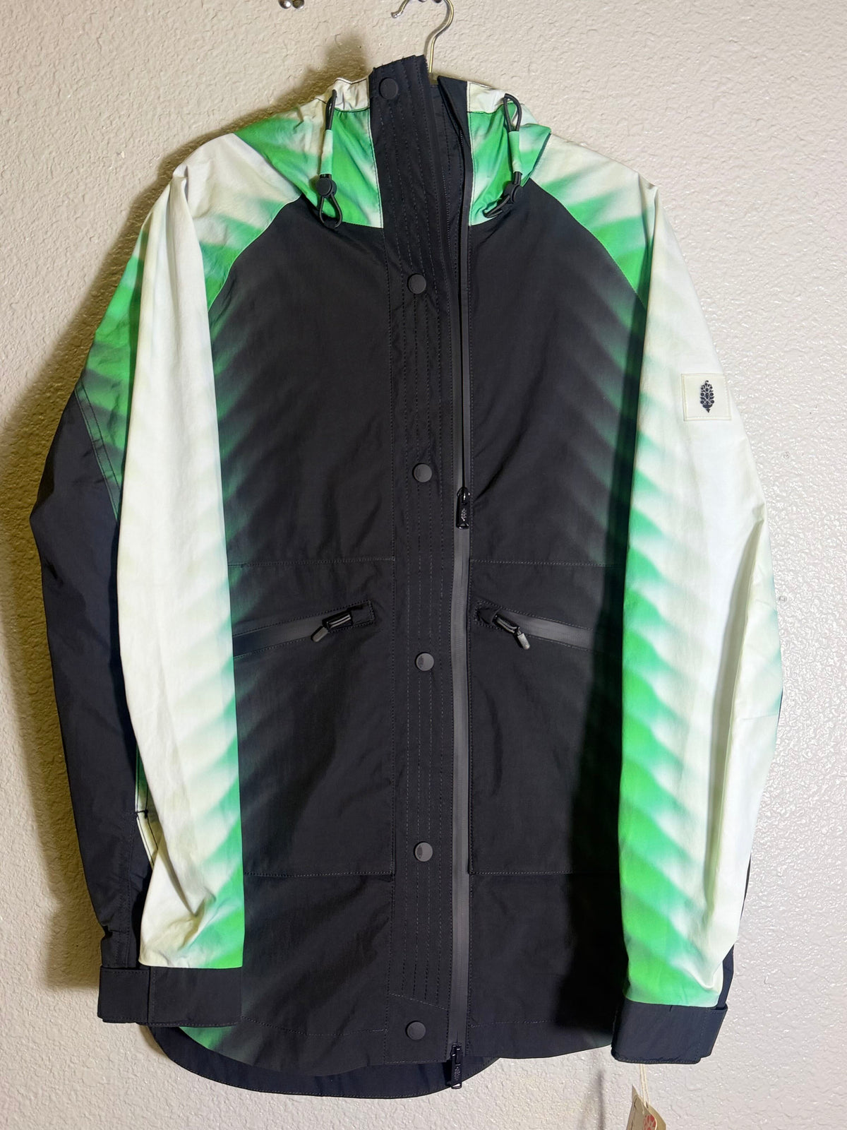 Green and black FP Movement Alien Combo Hooded Anorak jacket for women, XS size, featuring a zip front and hood.