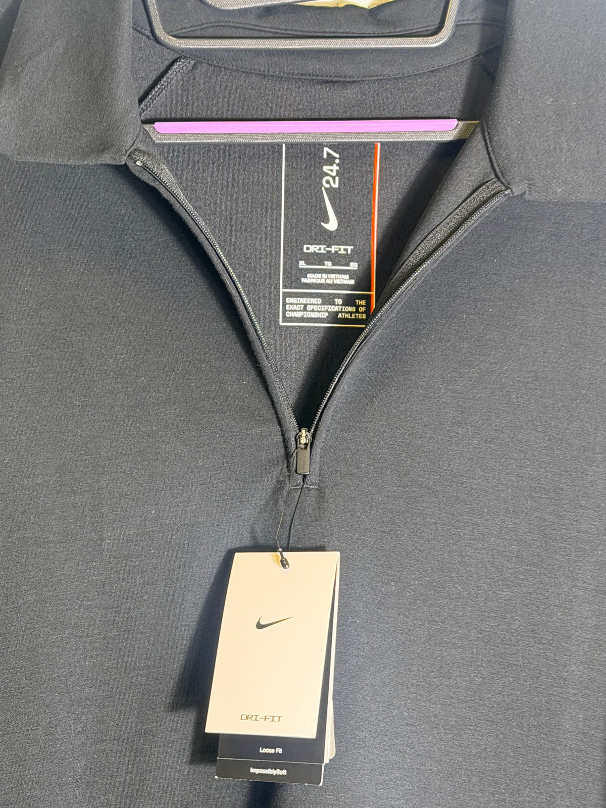 Black Nike 24.7 ImpossiblySoft men's Dri-FIT 1/4-zip polo shirt, size XL, displayed on a hanger.