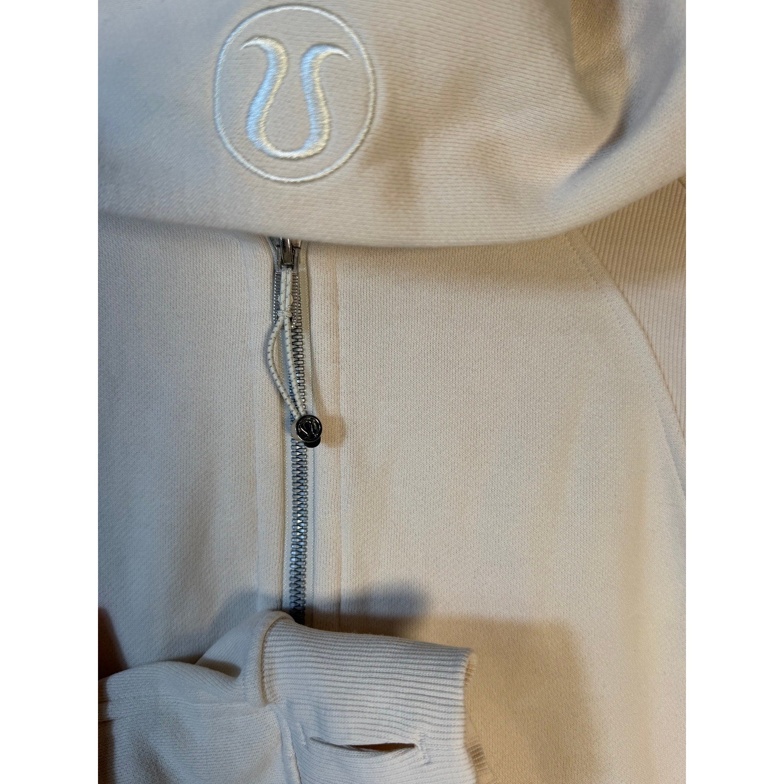 Lululemon women's cream scuba half-zip hoodie in oversized fit, showing the soft fabric and relaxed style.