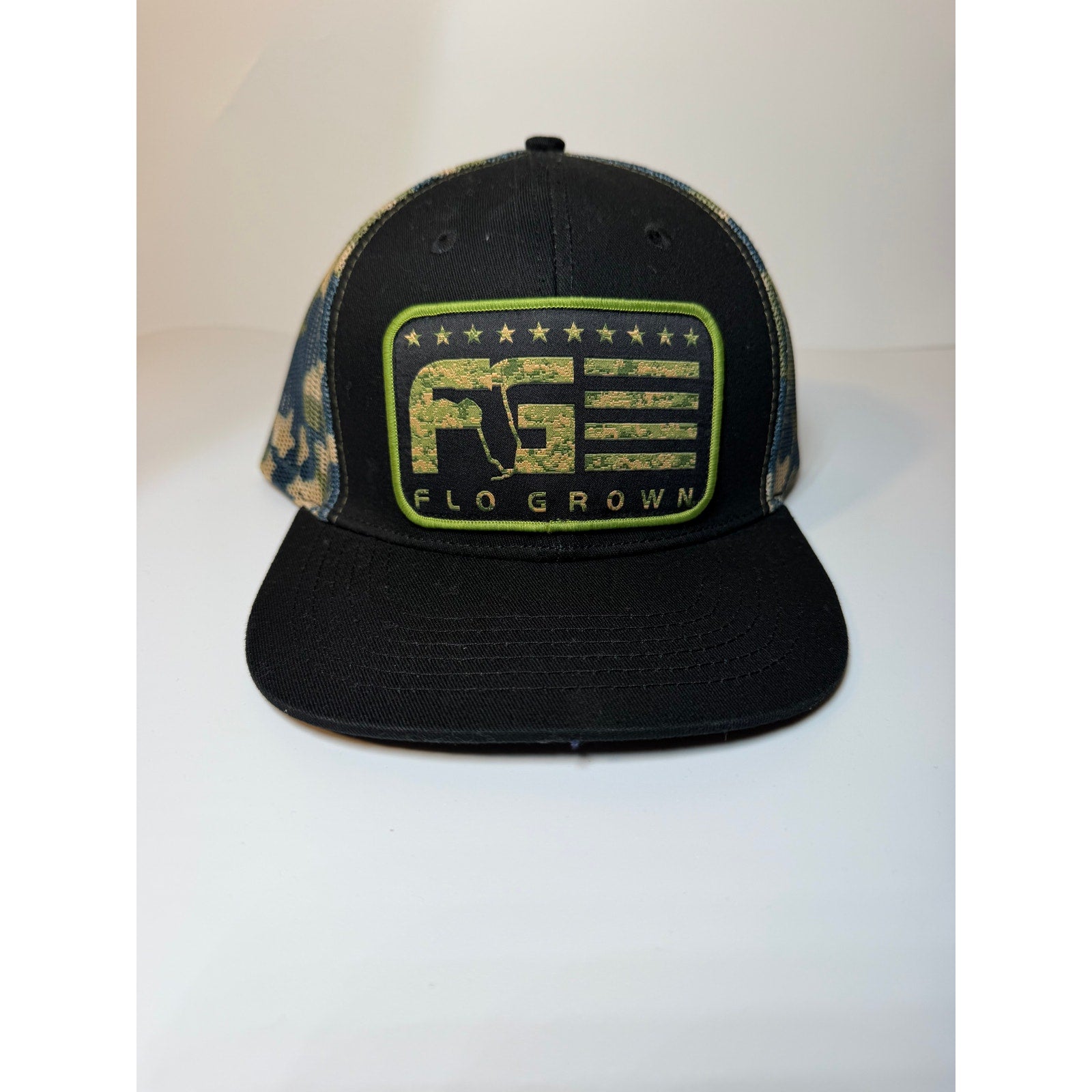 FloGrown Florida flag trucker hat with black camo mesh and snapback adjustable strap, showcasing bold Florida-themed design.