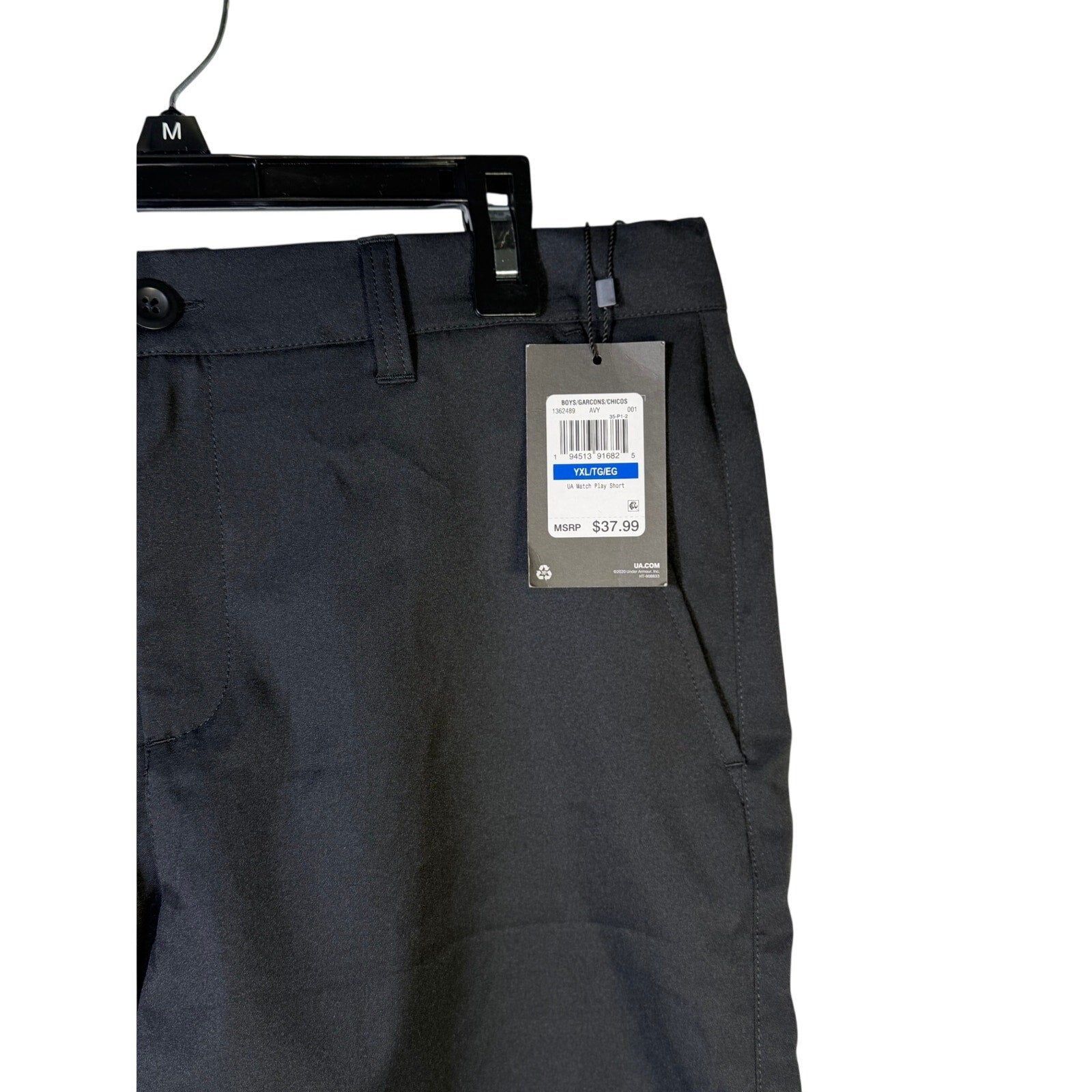 Under Armour youth boys' black Match Play golf shorts made of performance stretch fabric, shown on a young boy.