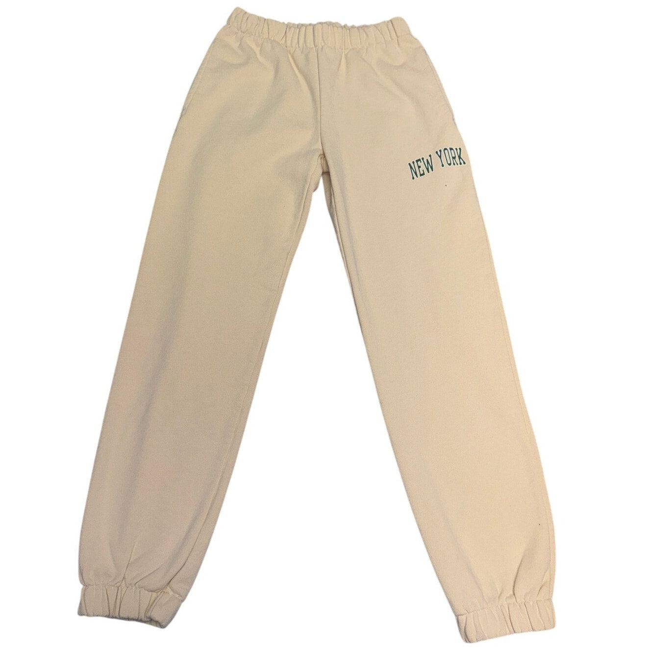 Cream beige Brandy Melville New York graphic jogger sweatpants with elastic waistband, size L, casual and comfortable fit.