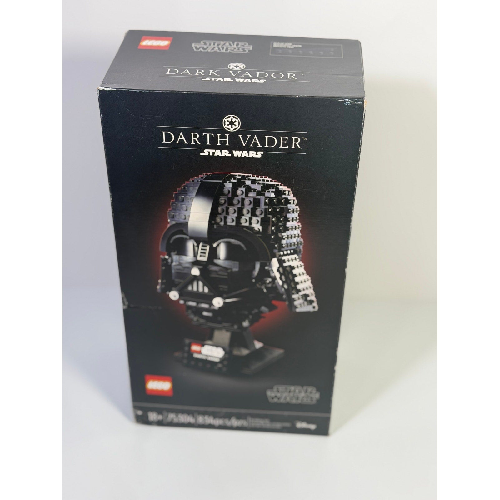 LEGO Star Wars Darth Vader Helmet set 75304 with 834 pieces, showing assembled helmet and box for adult collectors.